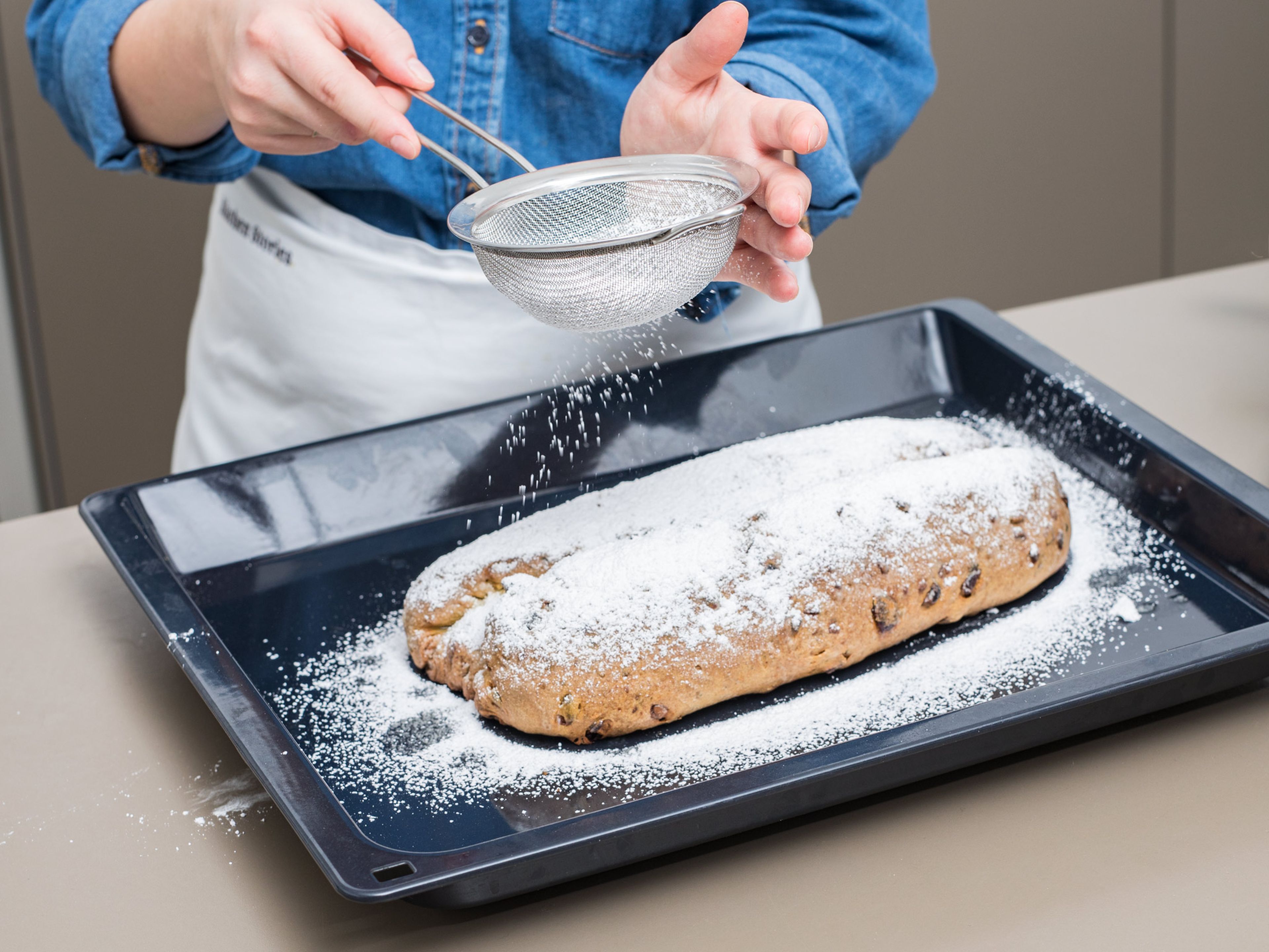 Melt butter in a small saucepan. Once stollen is golden brown all over, remove from oven and brush with melted butter. Dust with a thick layer of confectioner’s sugar. Repeat once more with the butter and confectioner’s sugar. Enjoy!