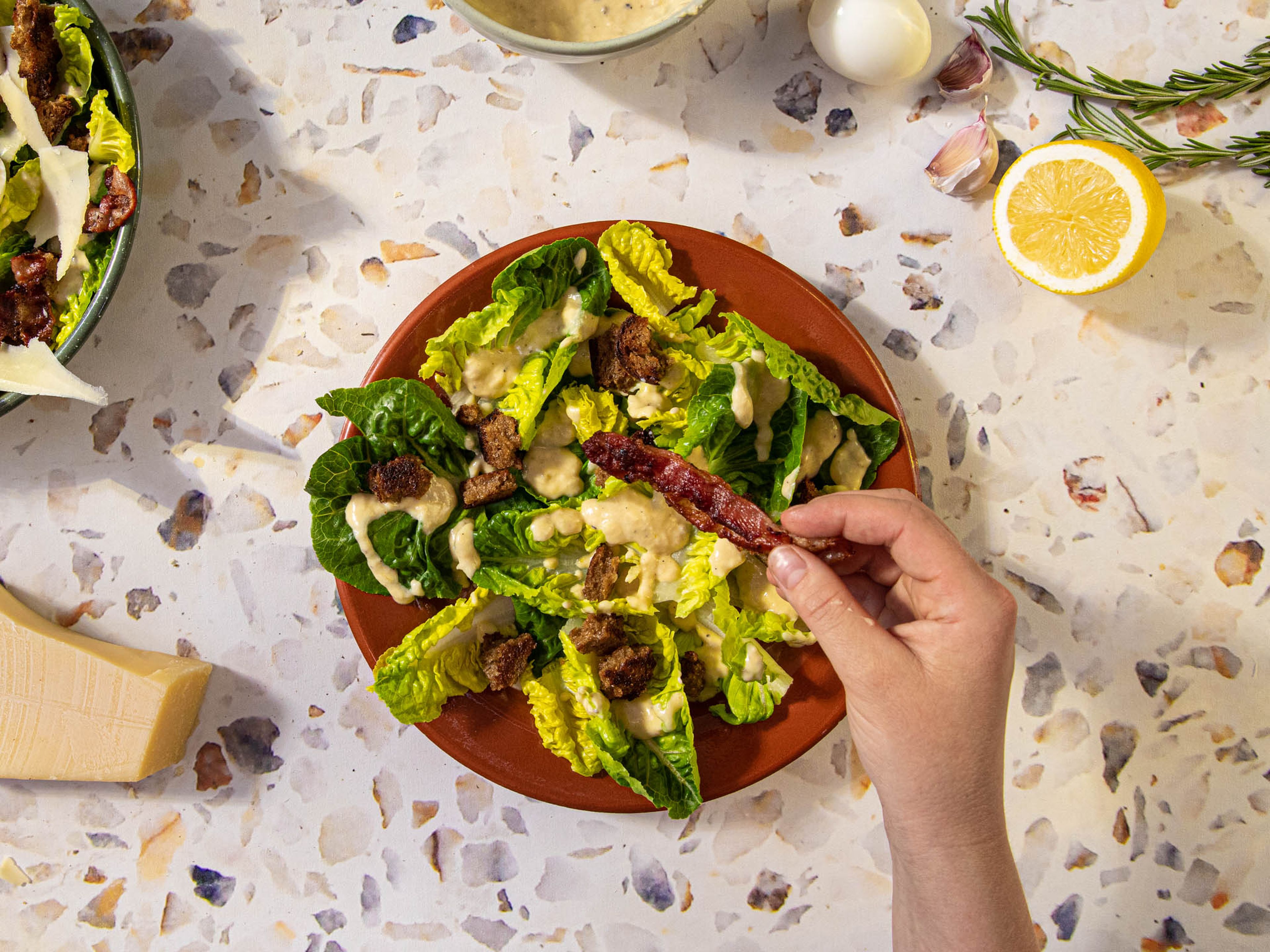 To assemble the salad, tear romaine leaves into a bowl, add croutons, pour dressing, and break the bacon into pieces on top, then add boiled eggs. Serve with extra grated Parmesan. Enjoy!