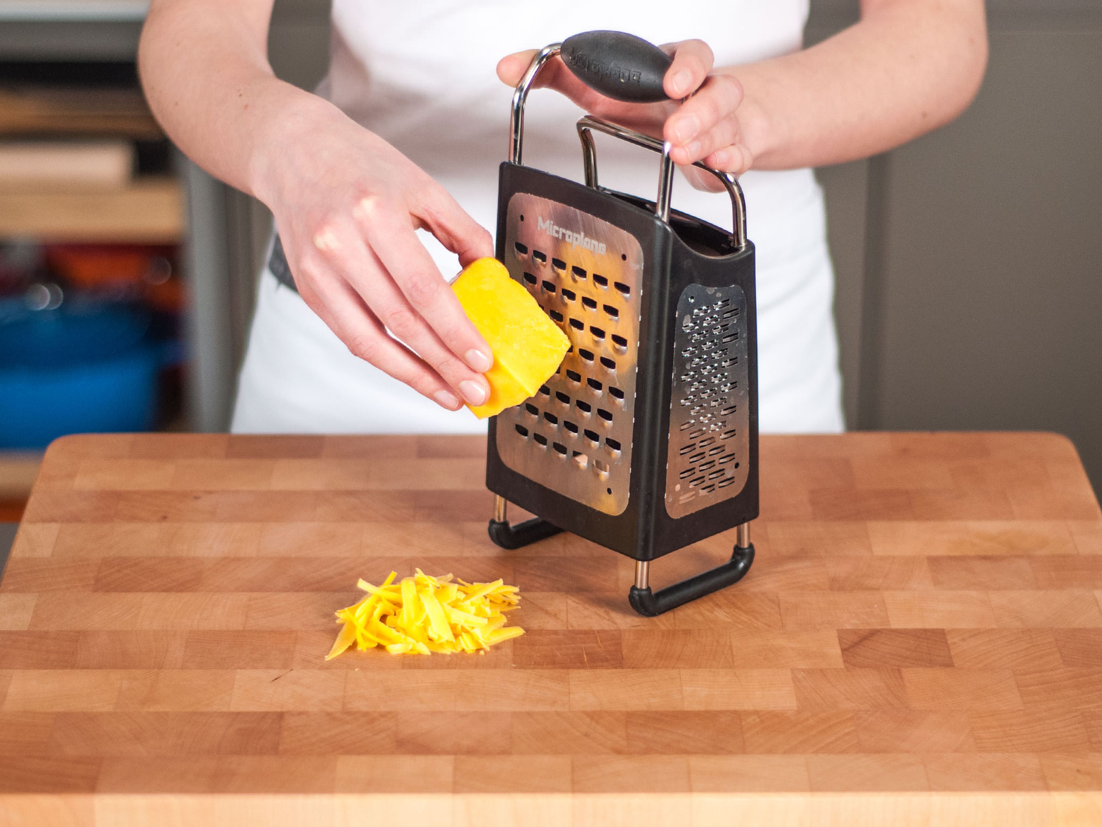 Grate cheddar cheese.