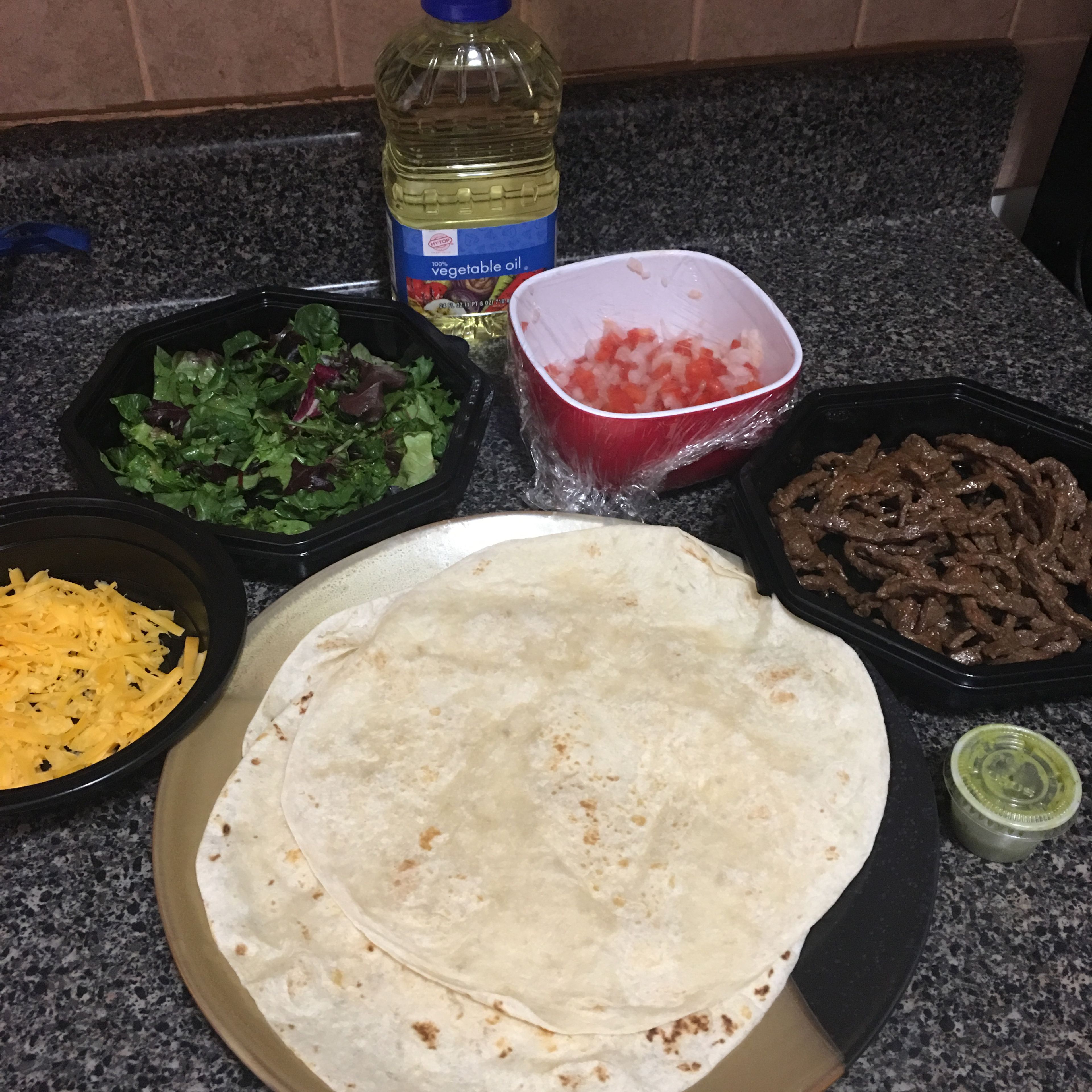 Cook the tortillas in a pan (2 min. Each side). Take a tortilla, add the salsa verde, add the meat, lettuce, bell pepper and onion, top with cheese and roll it.