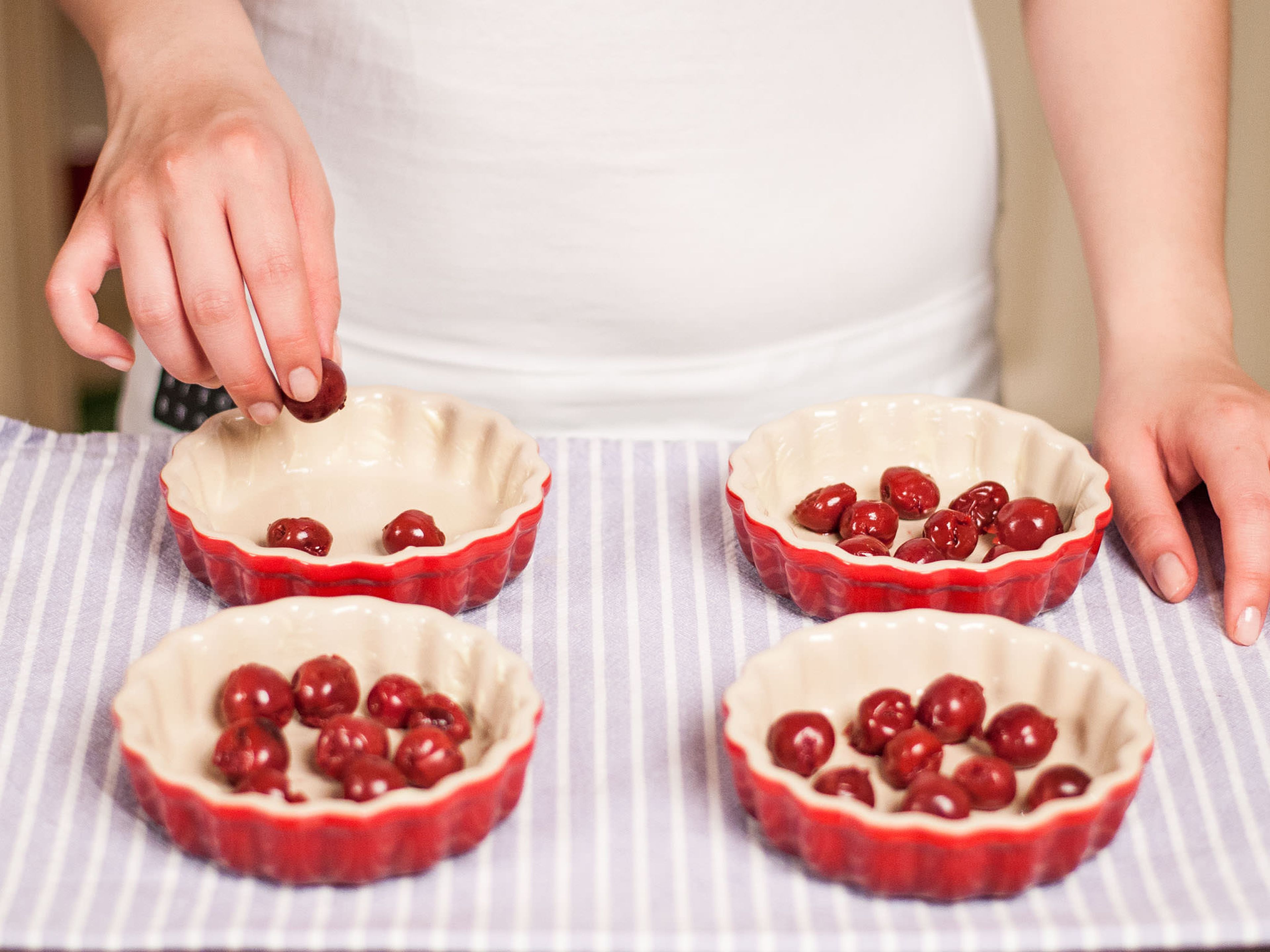 Drain cherries and place into baking tins.