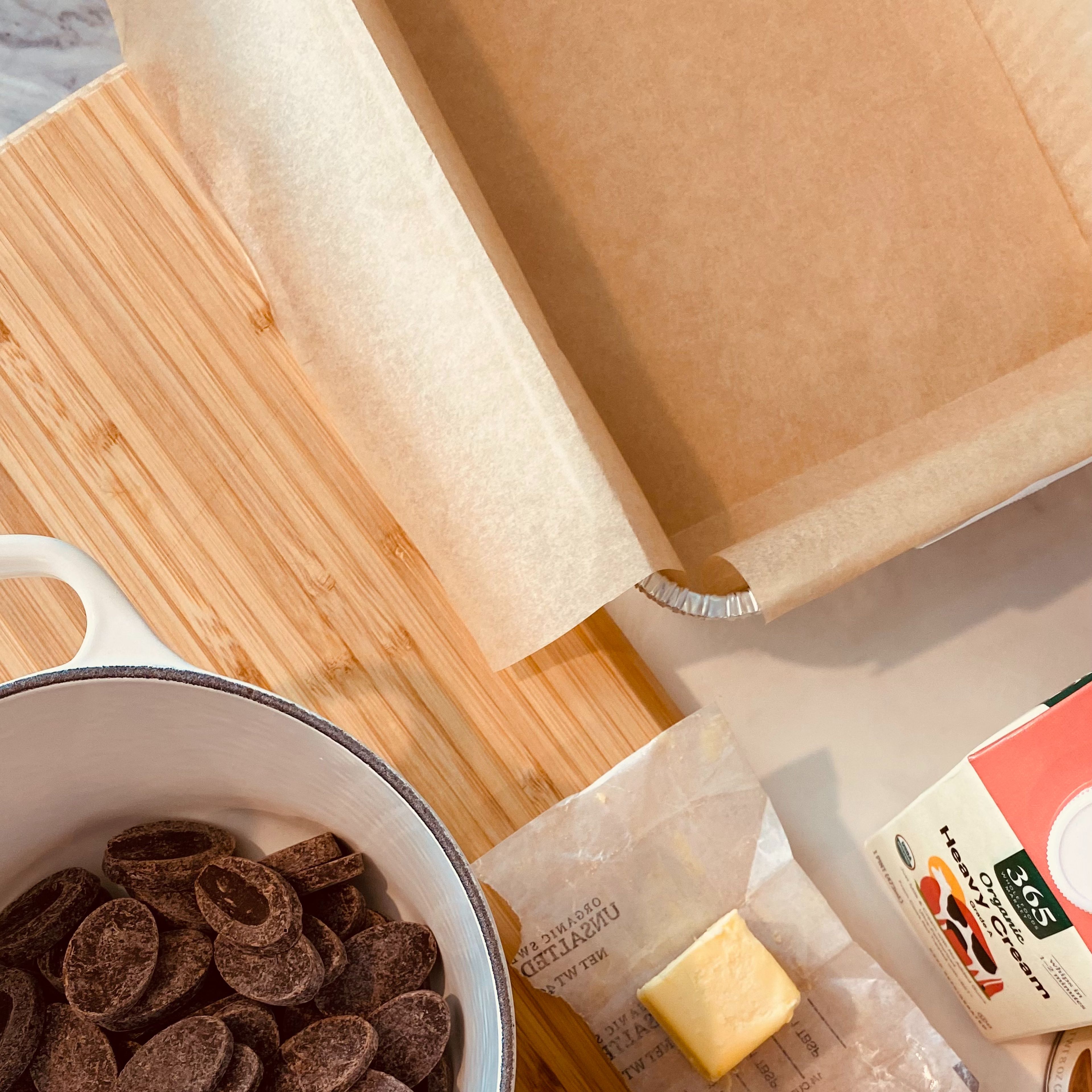 Line a baking tray, or any type of square case with parchment paper. Make sure to cut the parchment paper long enough to cover the sides and edges, so you can remove the chocolate easily.