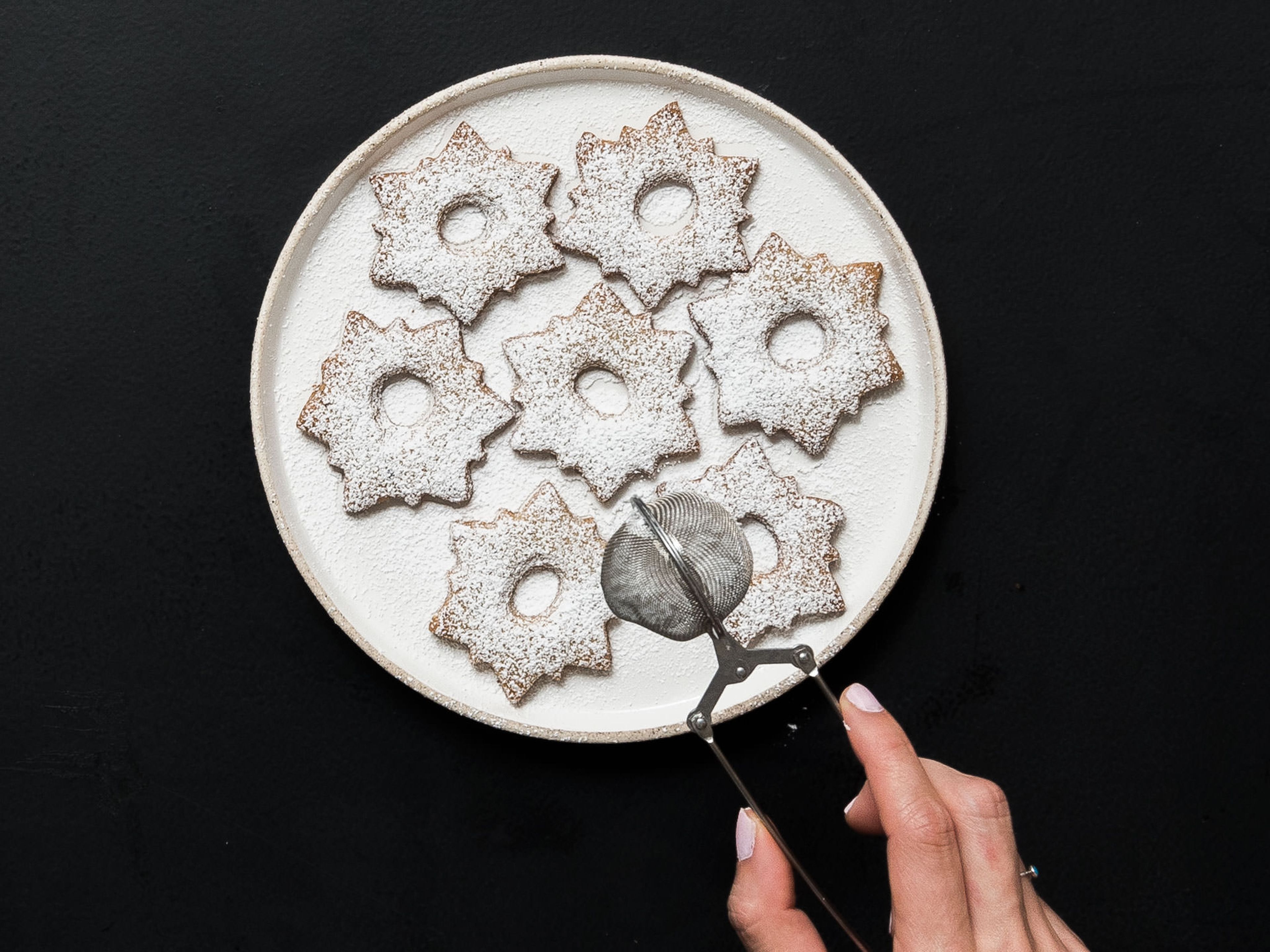 When cookies have cooled completely, dust the cookies with the hole with confectioner’s sugar.