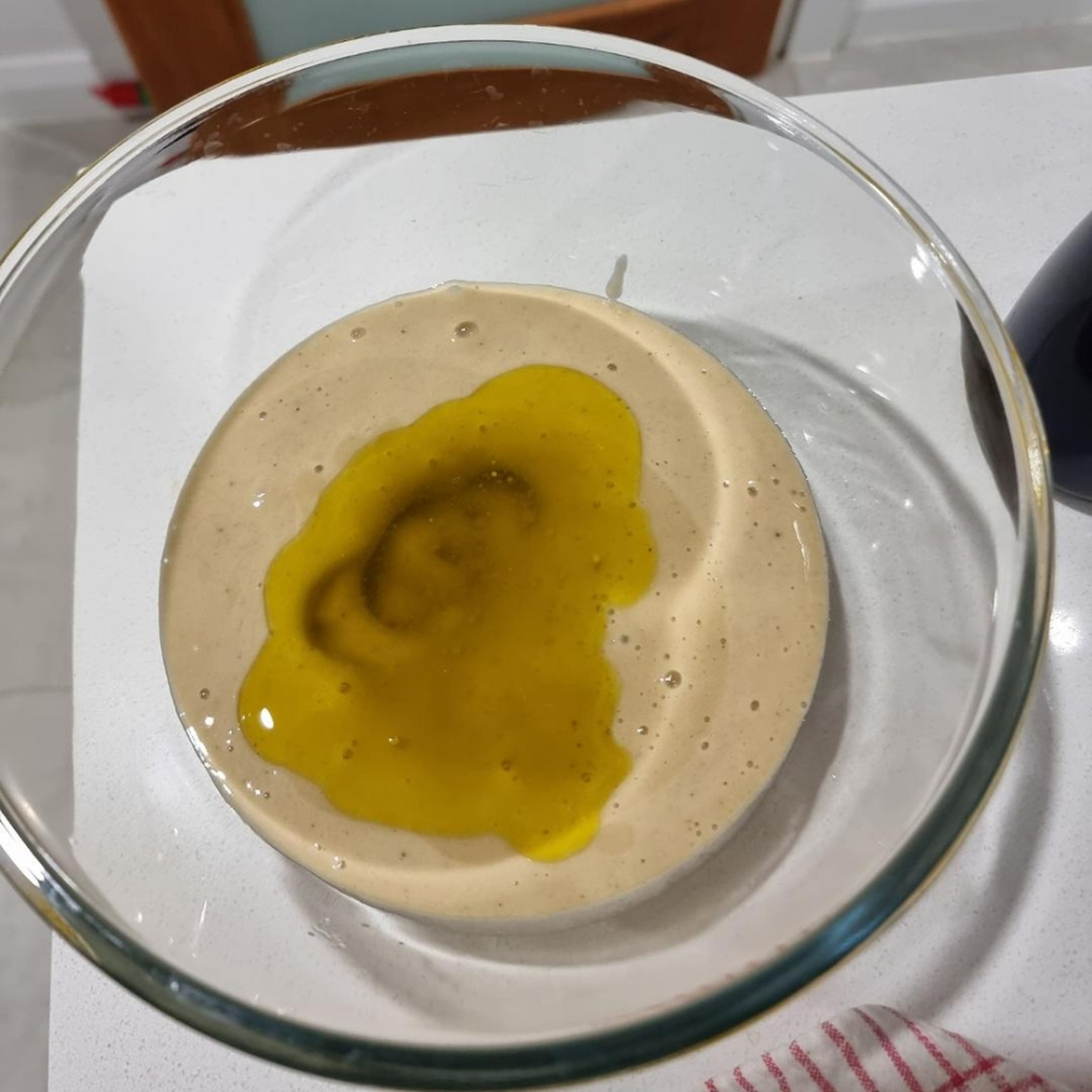 put the banana puree in a bowl and add oil .mix it well