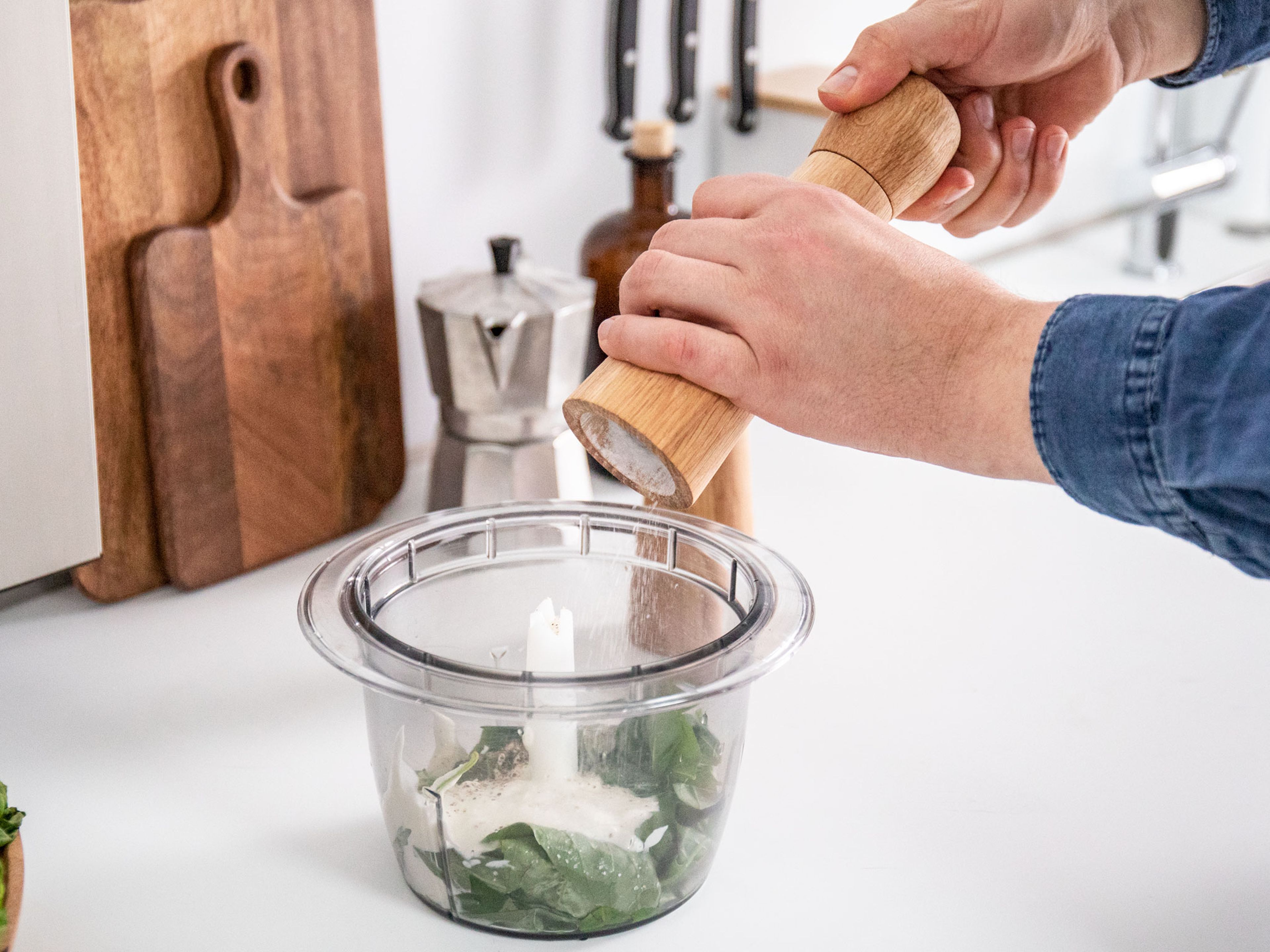 To make the basil yogurt, add some basil, Greek yogurt, one third of the garlic, and lemon juice to a food processor. Season with salt and pepper, then process to a smooth green sauce. Season to taste and keep the basil yogurt in the fridge until serving.