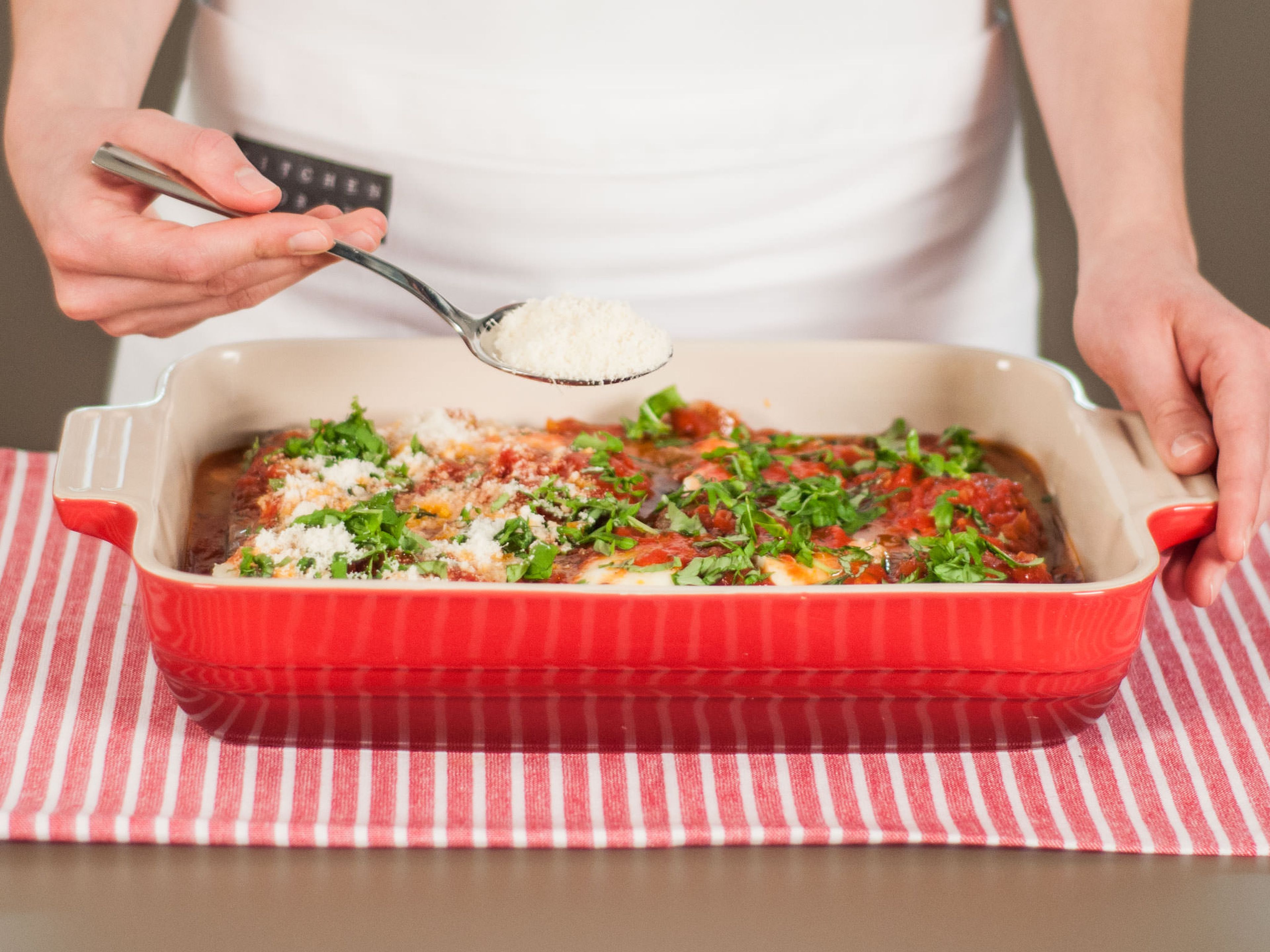 Preheat oven to 180°C (350°F). Top off dish with basil and Parmesan. Transfer to oven and bake for approx. 20 – 25 min. until golden brown. Garnish with fresh basil leaves and enjoy warm!