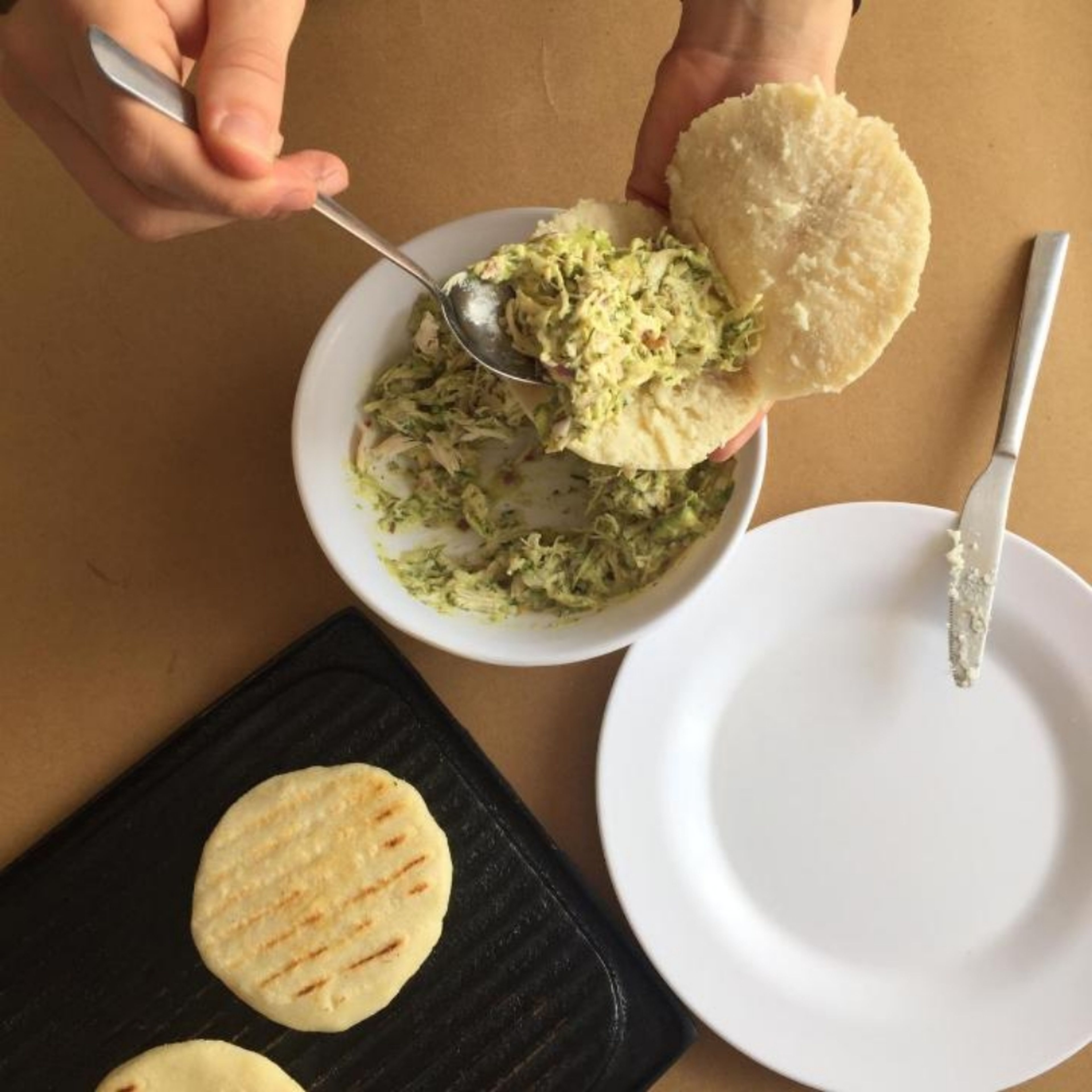 Once the arepas are ready, let cool a few minutes before handling. Carefully slice the arepas way through, creating a pocket. Fill with the previously prepared filling in quantities.