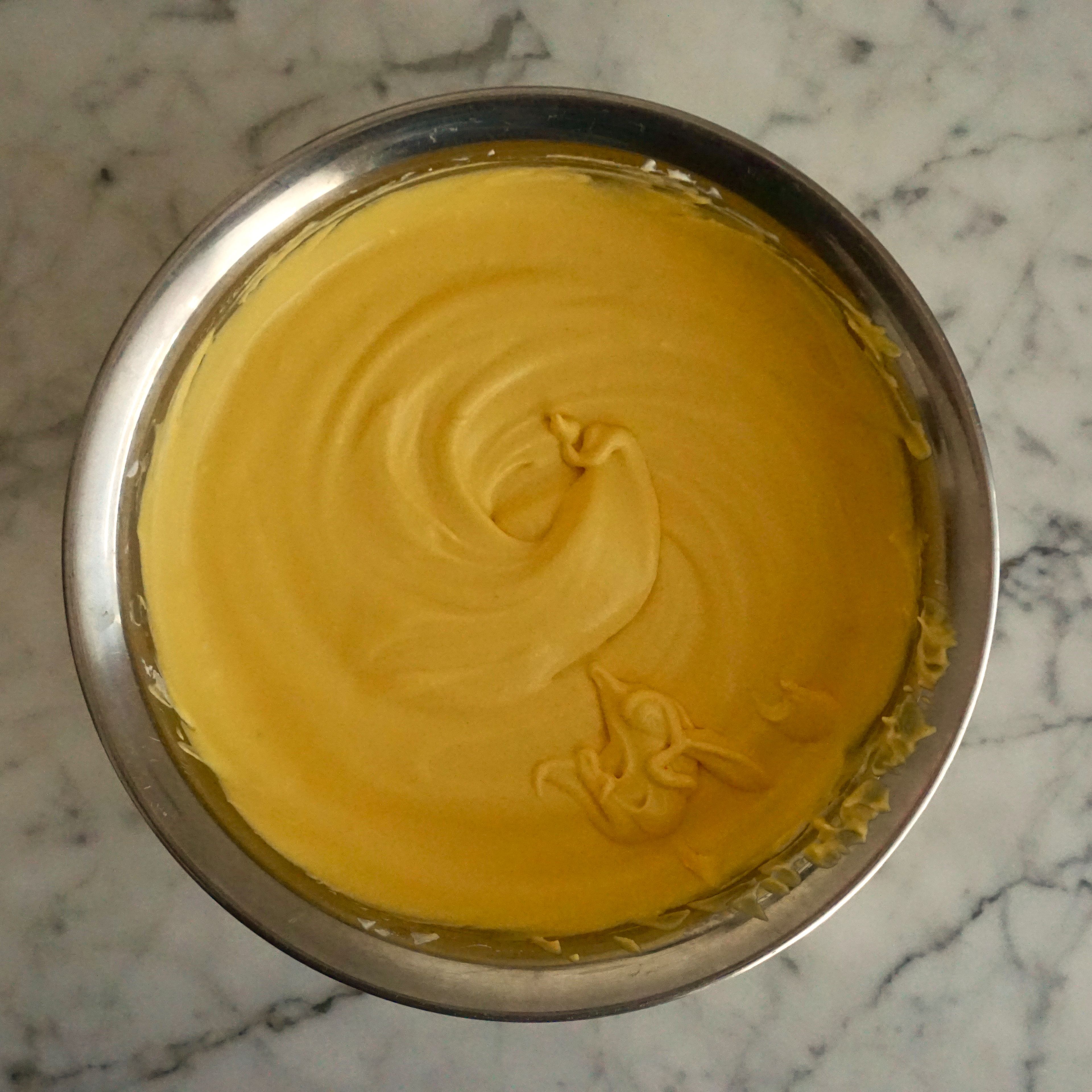 300g Sahne halb aufschlagen. Geschlagene Sahne kalt stellen. 4 Gelatineblätter in kaltem Wasser einweichen. Ca. 50g Mangopüree in der Mikrowelle erwärmen und eingeweichte Gelatine darin auflösen. Mit 250g Mangopüree und 2 EL Zitronensaft angleichen. Geschlagene Sahne unterheben. Mousse in Spritzbeutel füllen. Silikonform halbvoll mit Mousse füllen. Kern aus Mangokompott, Maracujacremeux und Dacquoise leicht hineindrücken. Form mit restlicher Mousse auffüllen. Torte über Nacht (min. 6h) gefrieren
