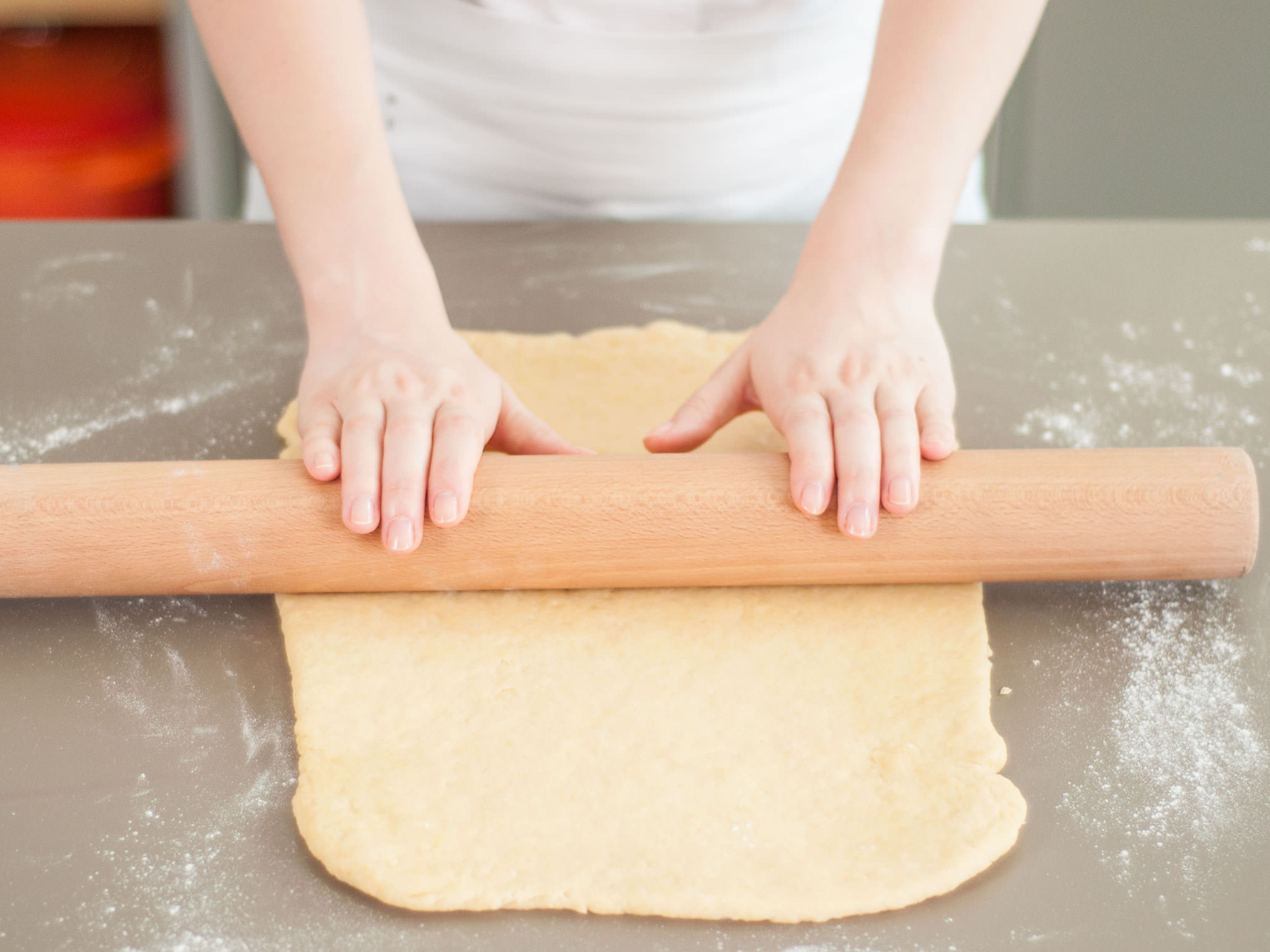 Mix together cinnamon, nutmeg, and some of the sugar. Grease a large rectangular baking dish with butter. Preheat oven to 180°C/350°F. Turn dough out onto lightly floured surface, knead a couple of times until smooth, and roll out to fit the baking pan.
