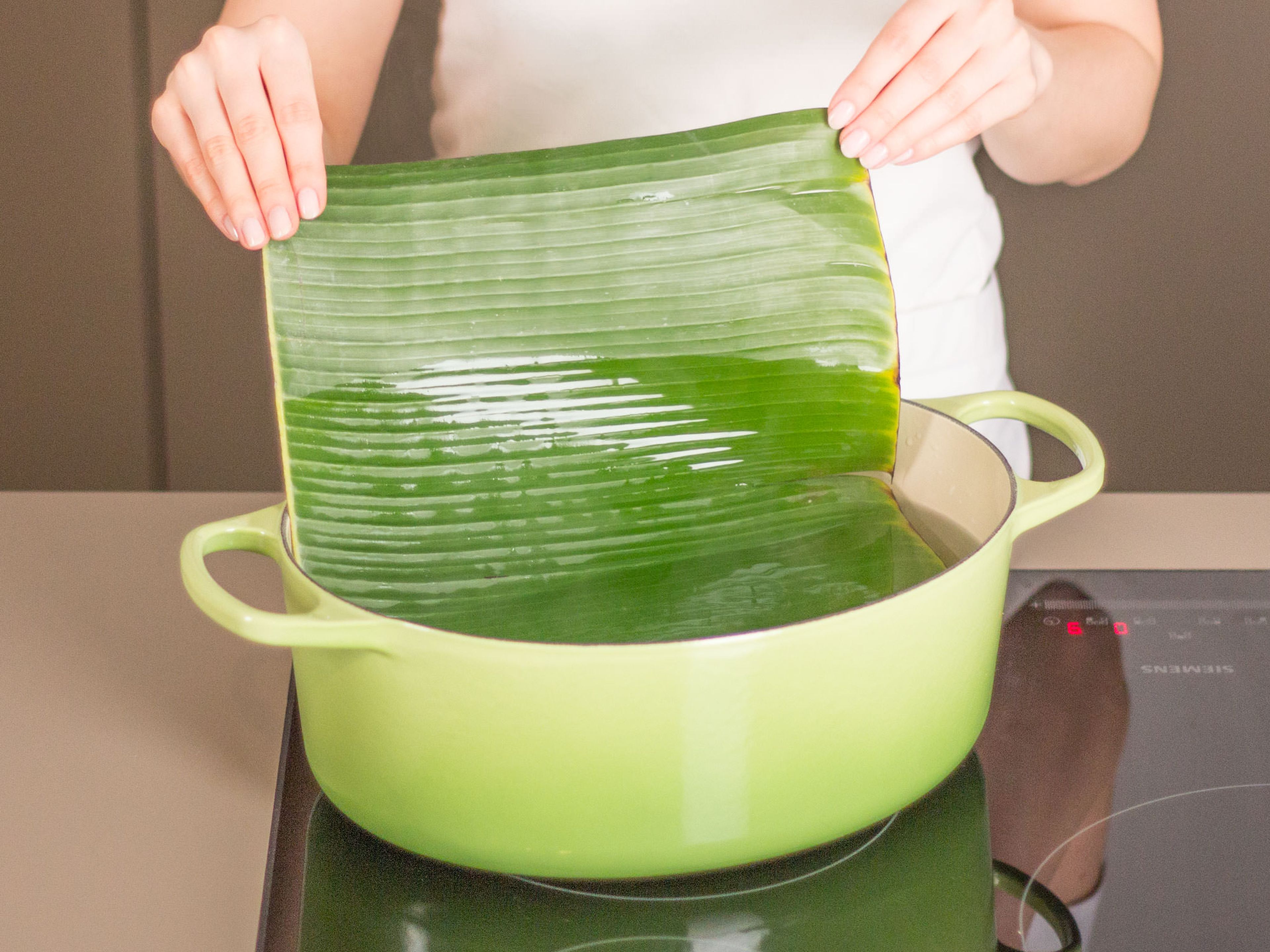 Cut banana leaves in into pieces large enough to wrap around cod pieces. Heat water in a large saucepan: do not boil. Add banana leaves one at a time for approx. 2 min., or until softened.