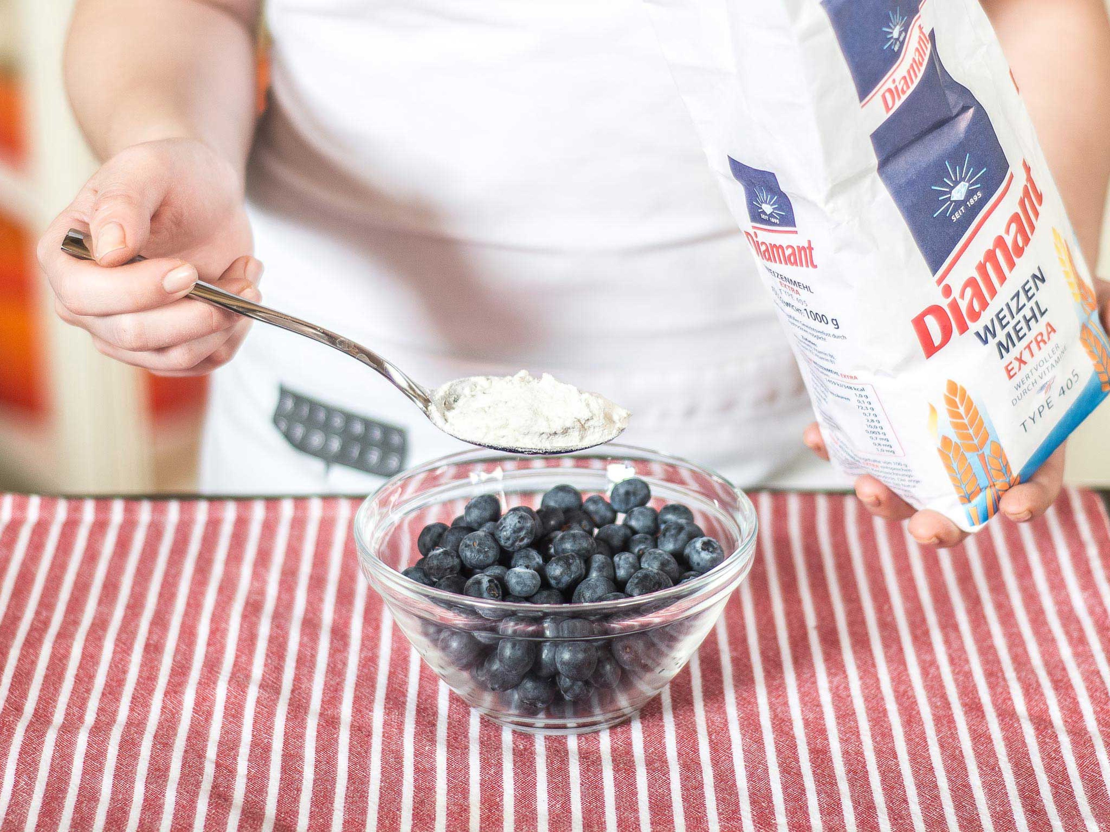 In another bowl, mix blueberries with the rest of the flour. This slight coating prevents them from sinking to the bottom during baking.