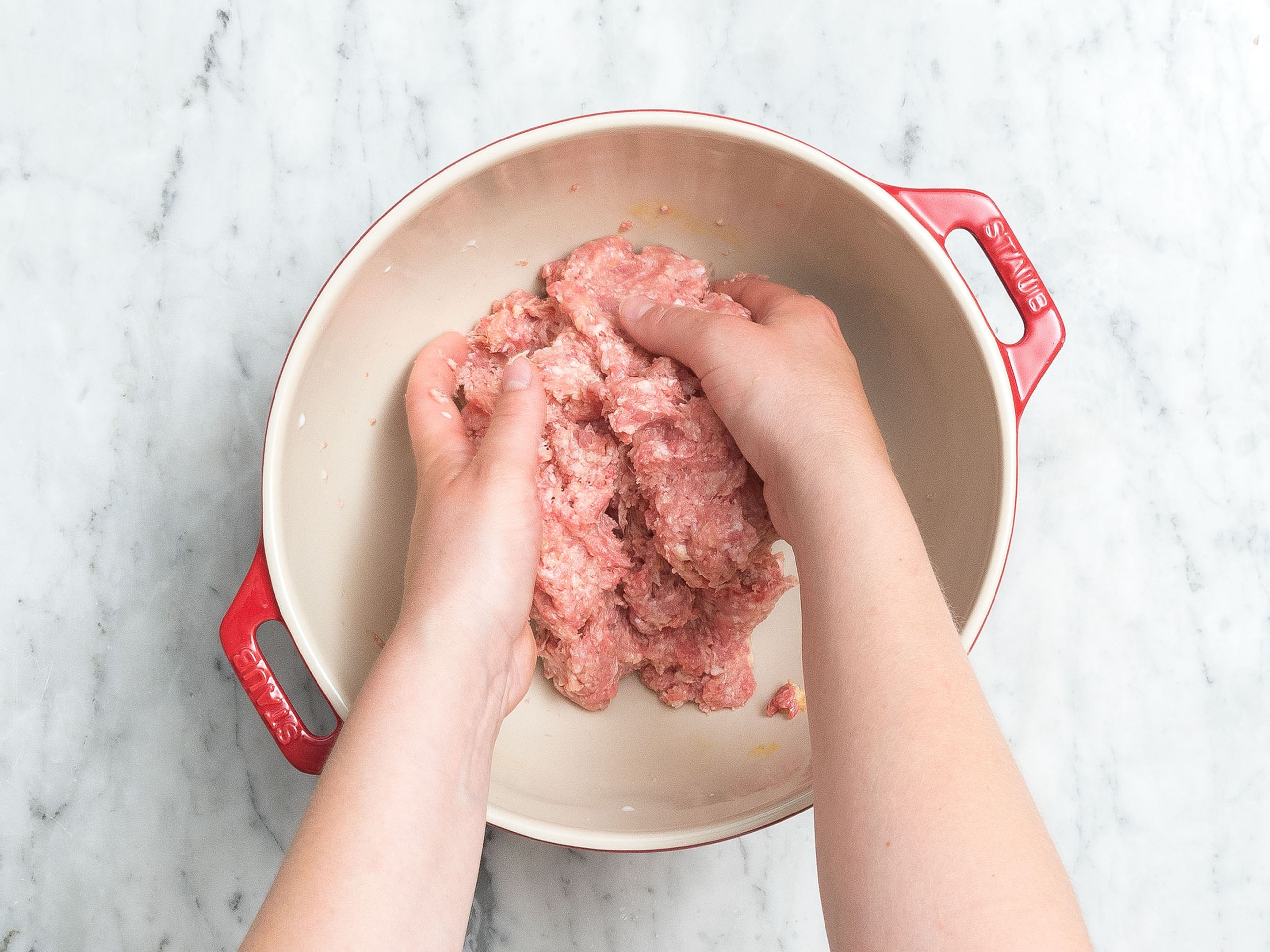 Add sandwich bread to a small bowl and let it soak in the milk. Add ground beef, ground pork, remaining egg, and soaked bread to a large bowl. Season with salt and pepper and mix with your hands to combine.