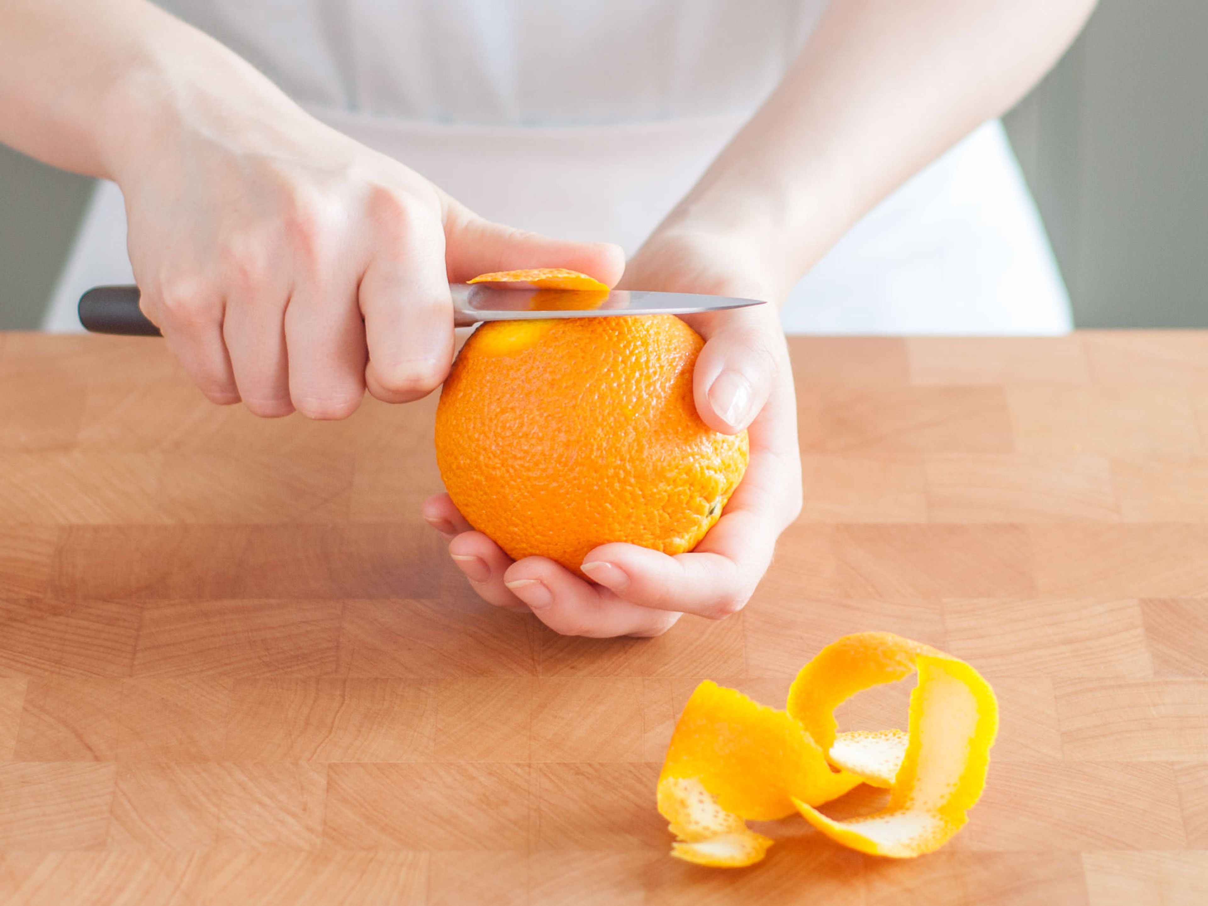 Cut one orange peel per glass.