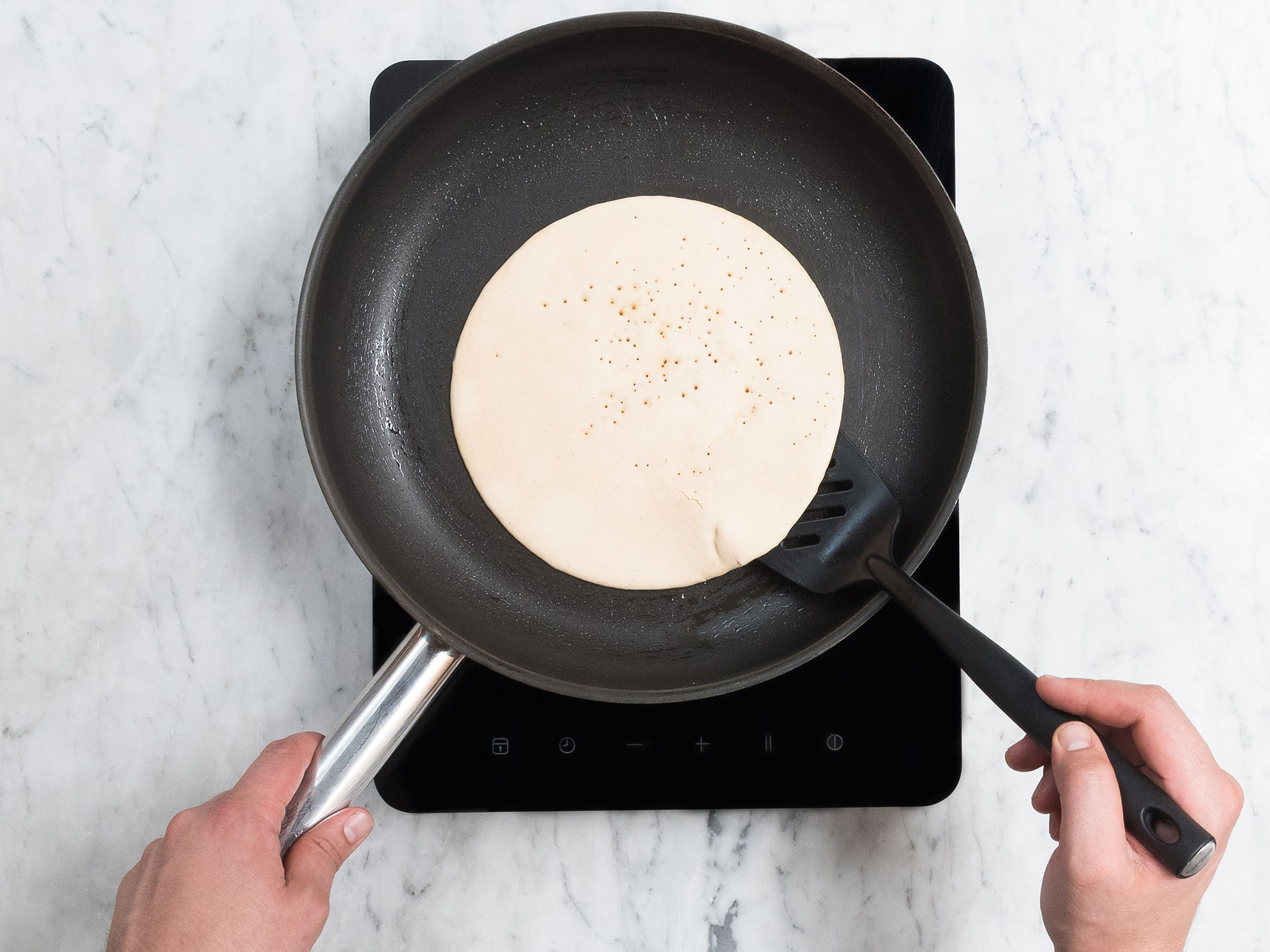 Remove dosa batter from fridge and stir. Heat clarified butter in a frying pan set over medium-low heat. Add one ladle of batter to the frying pan and tilt the frying pan so that you have an even layer of batter. Fry until golden brown on both sides, and repeat the process until you have used up all the batter.