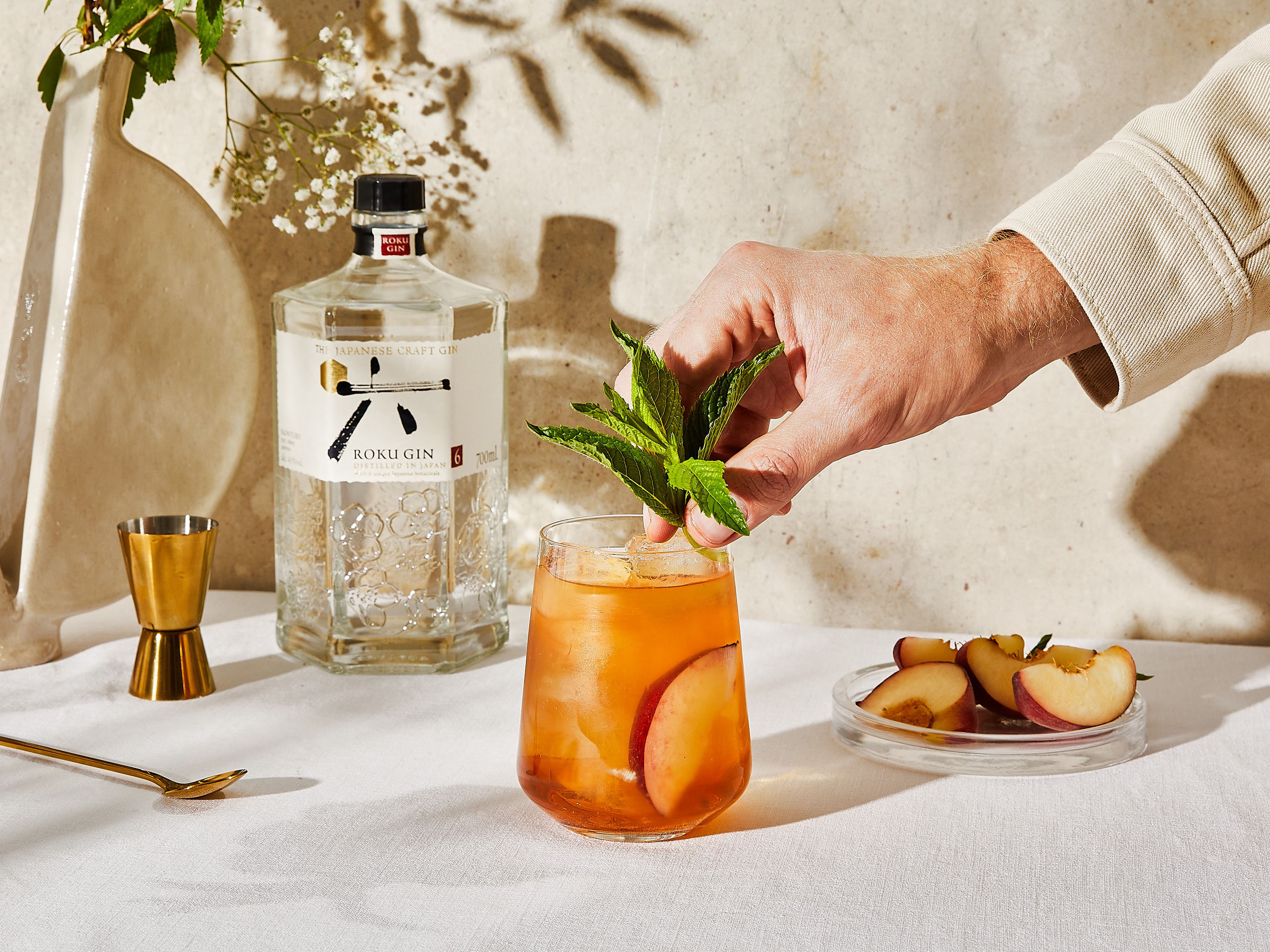 Garnish with fresh peach slices and mint to serve.