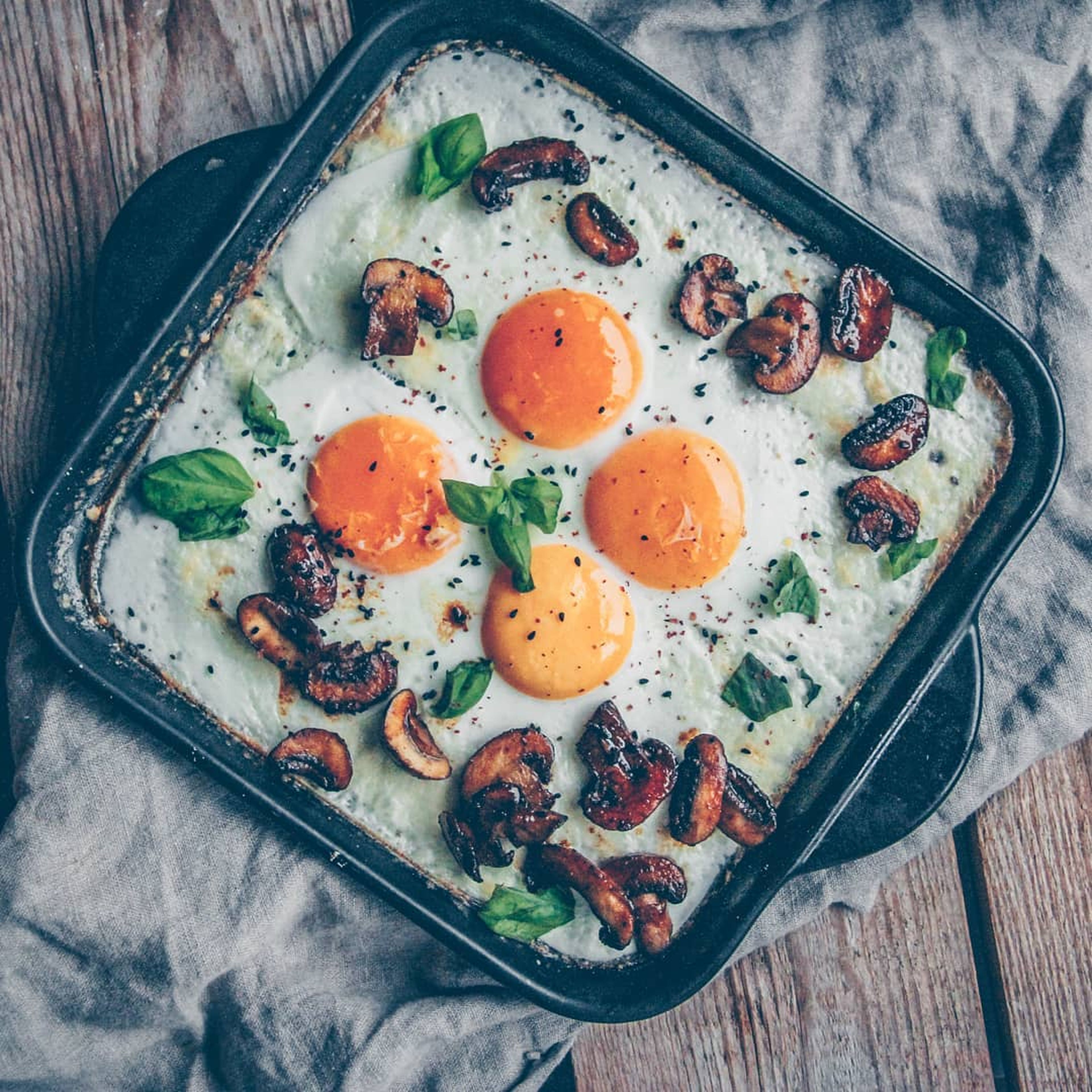 Baked eggs with caramelized mushrooms