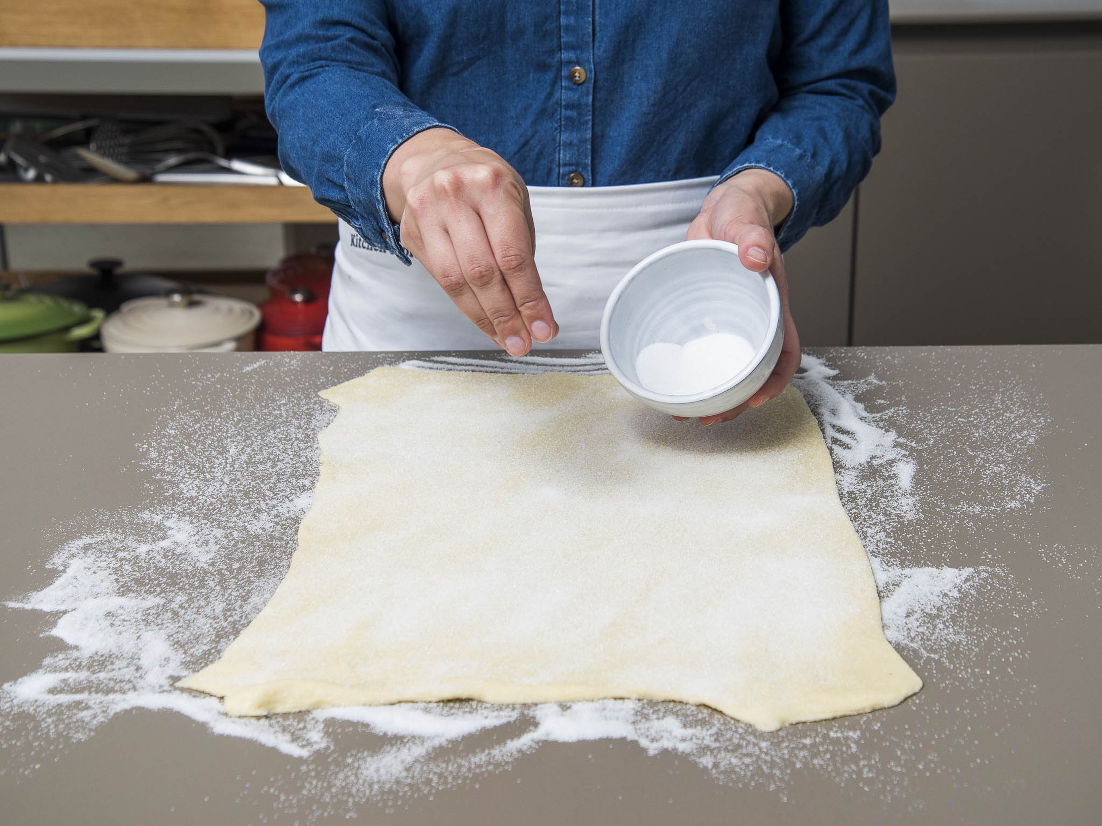 combine sugar and salt in a small bowl. Sprinkle some of the sugar mixture over a clean work surface, then place the puff pastry on top. Roll chilled pastry into a rectangle approx. 0.5-cm/0.25-inch.-thick, pressing the sugar into the dough. Sprinkle remaining sugar over the pastry, then lightly roll the pin over the sugar to press into the dough.