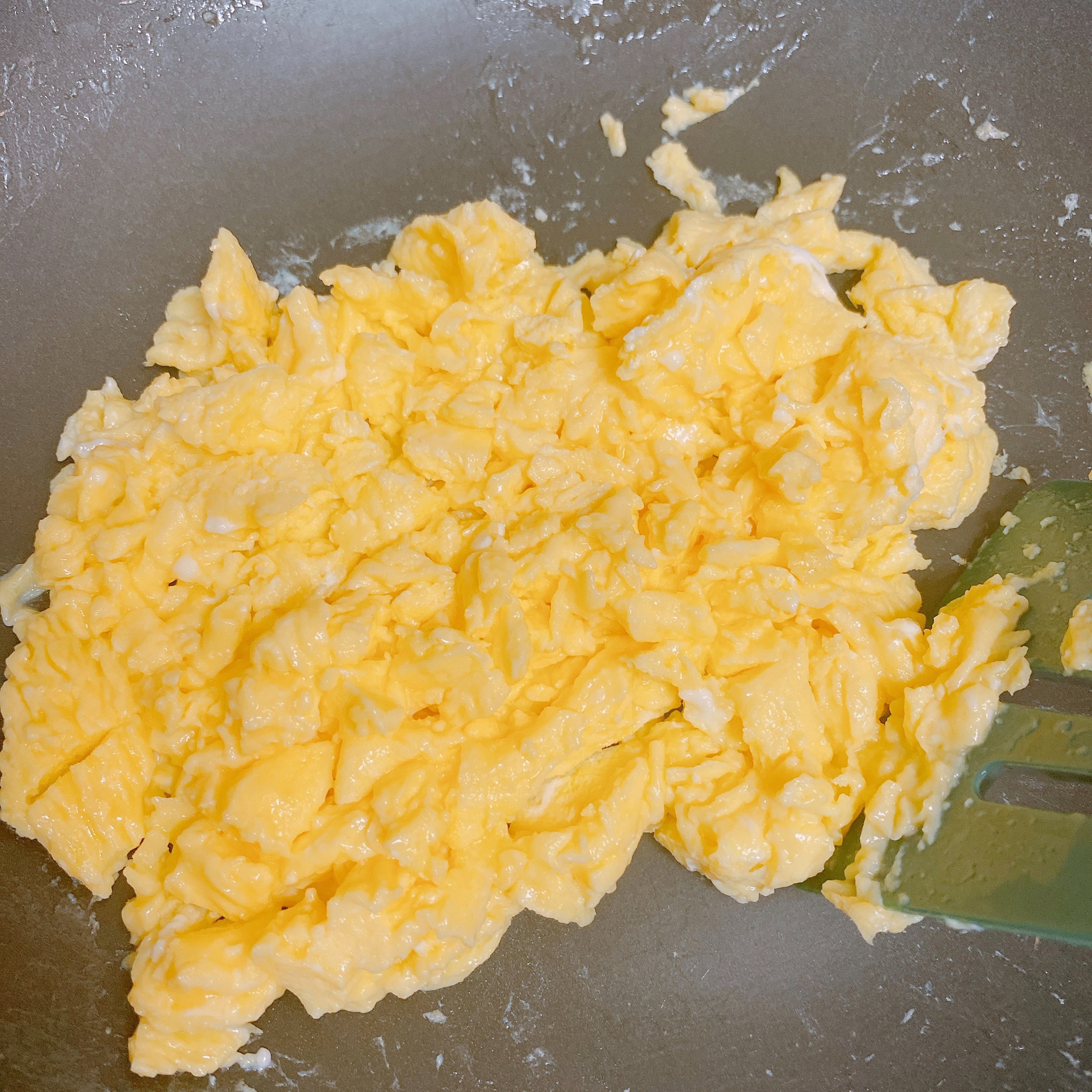Heat half of the oil and scramble the egg until it’s fully cooked. Pour it into a separate bowl.