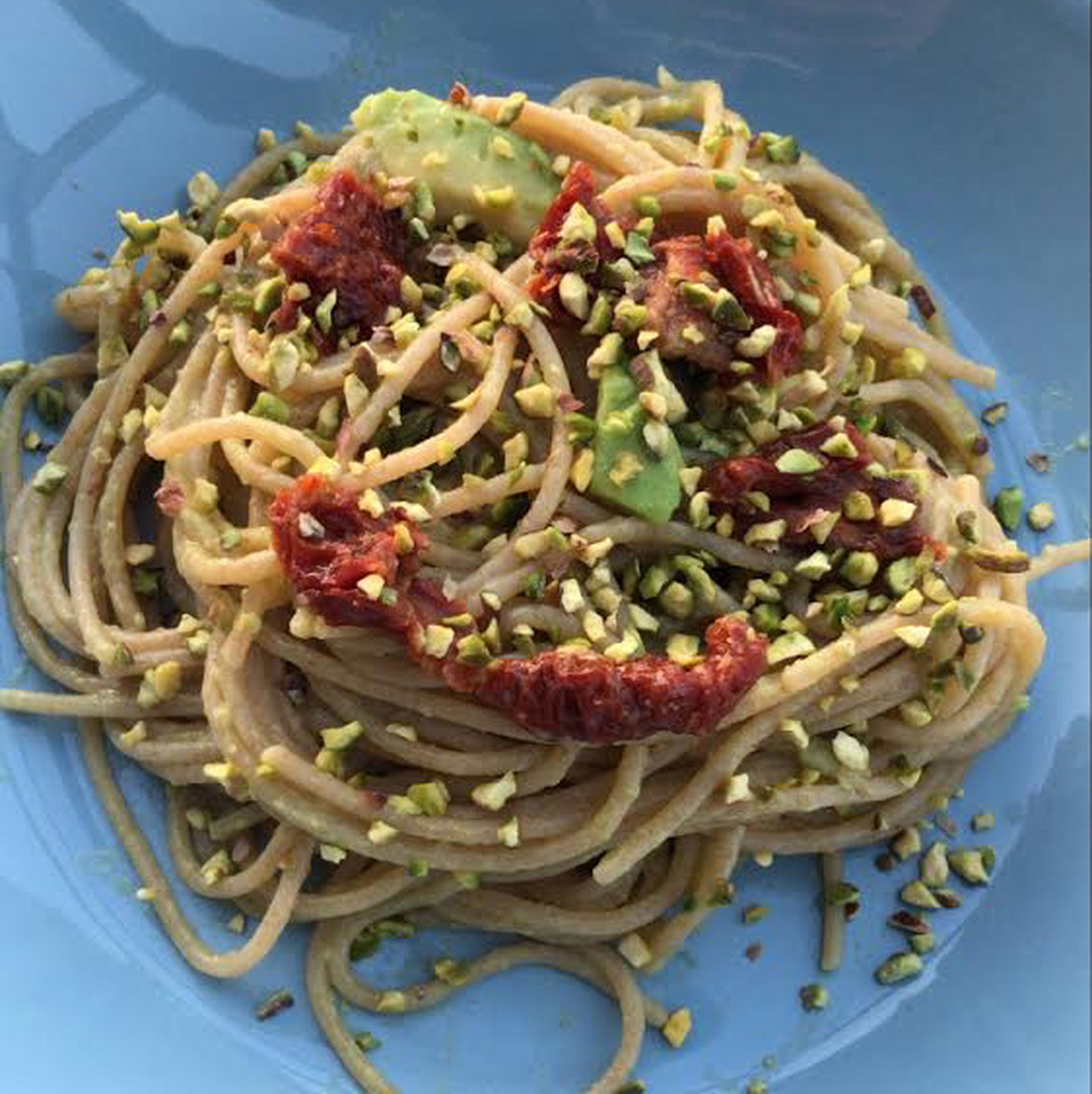 Wholemeal spaghetti with avocado cream and tomatoes
