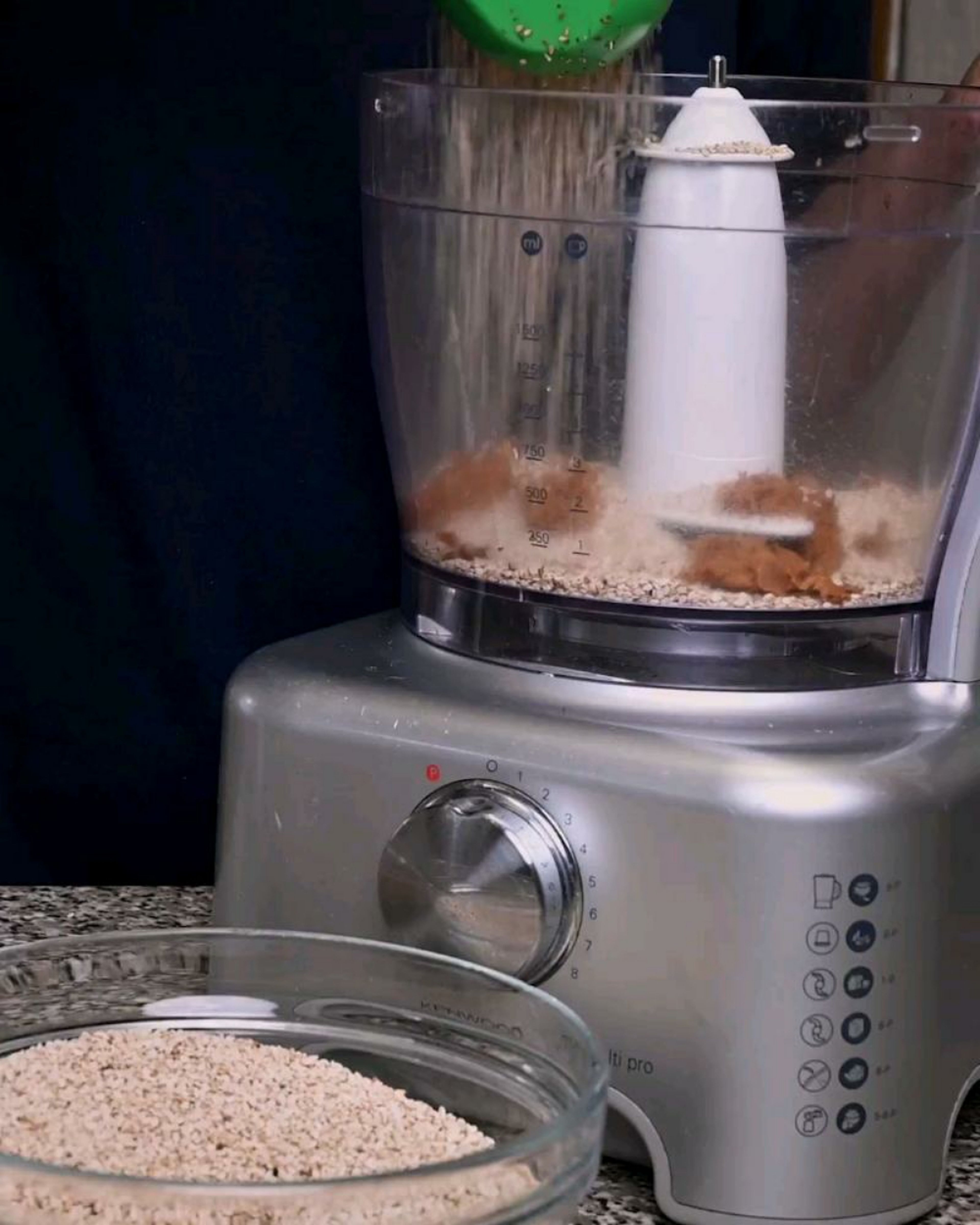In a food processor, add ½ cup of sesame seeds and then add ½ cup of the jaggery shavings.