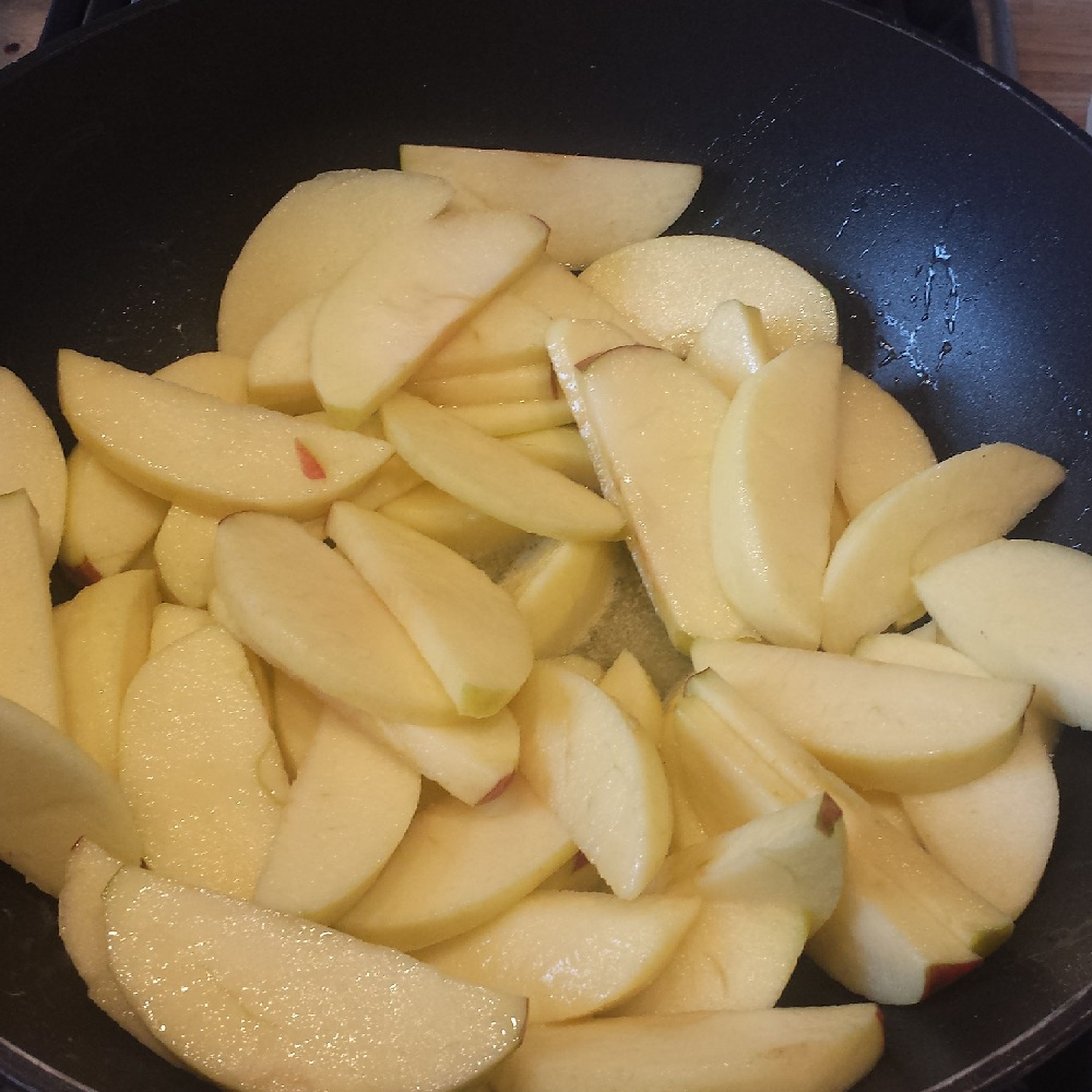 Peel, core, and slice apples. Melt remaining butter in a pan set over medium heat and add apple slices.