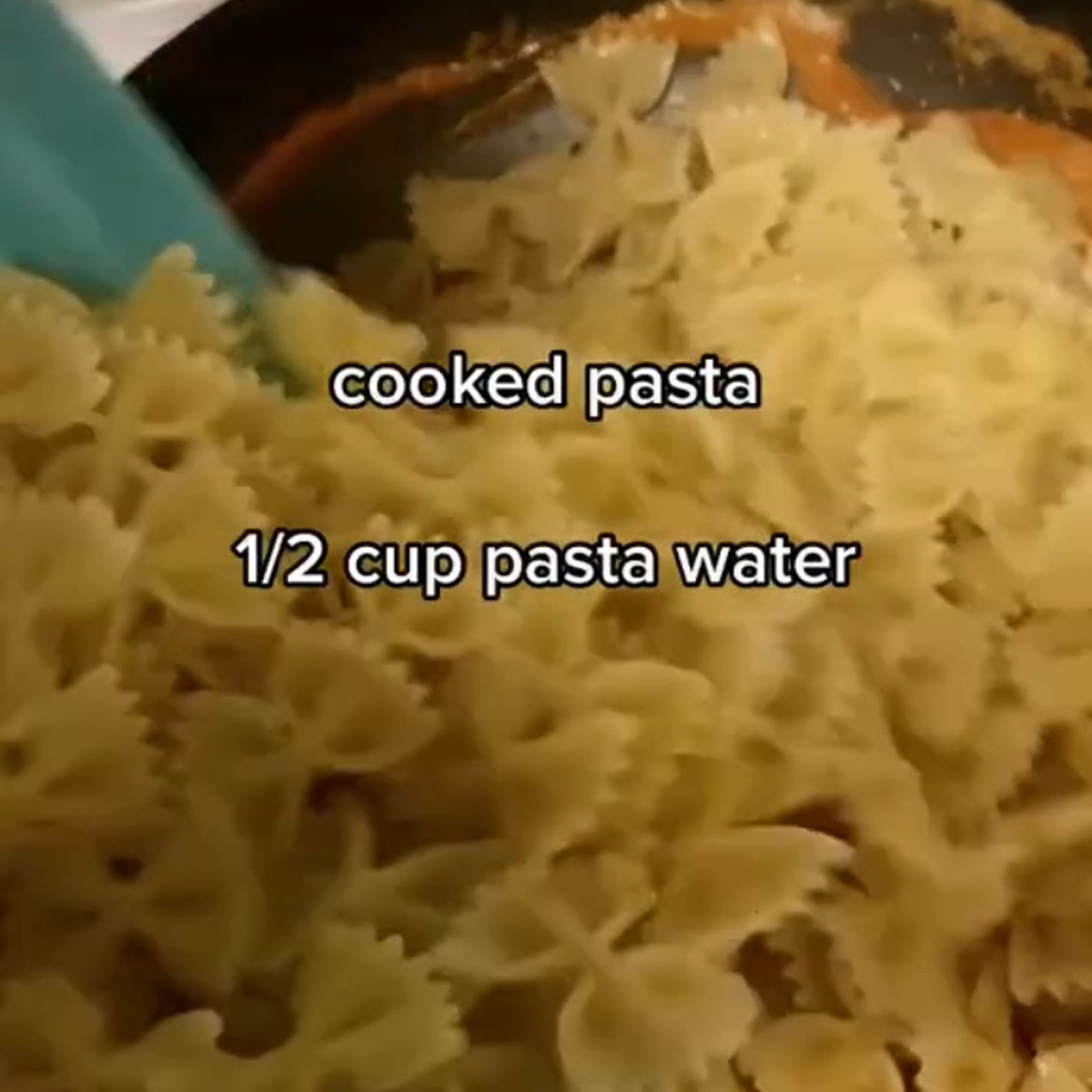 Pour the pasta into the pan, and the pasta water.
