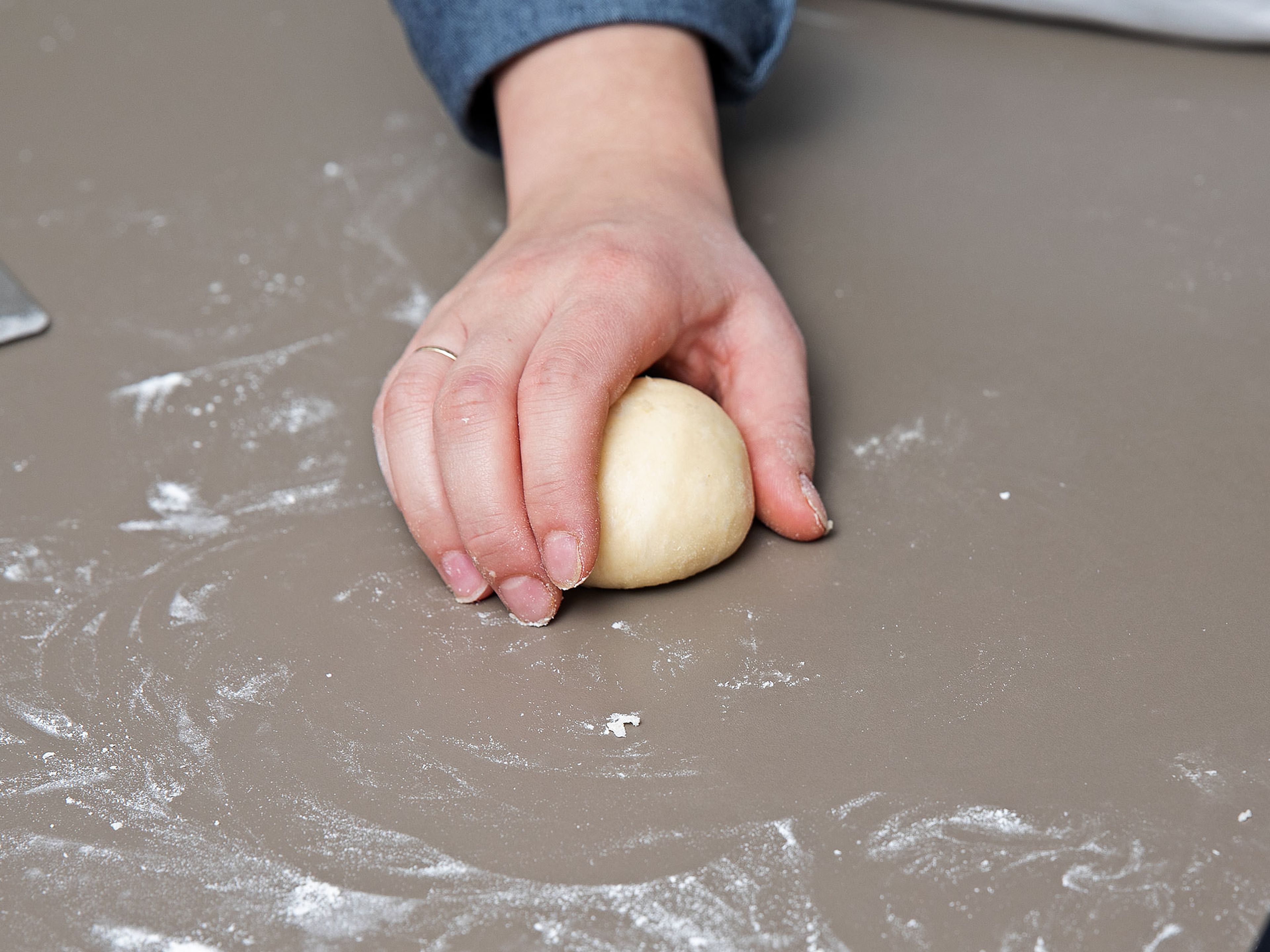 Cut the dough into even pieces and roll into balls. Place on a parchment-lined baking sheet, dust with flour and cover with kitchen towel. Let rise for at least 1 hr.