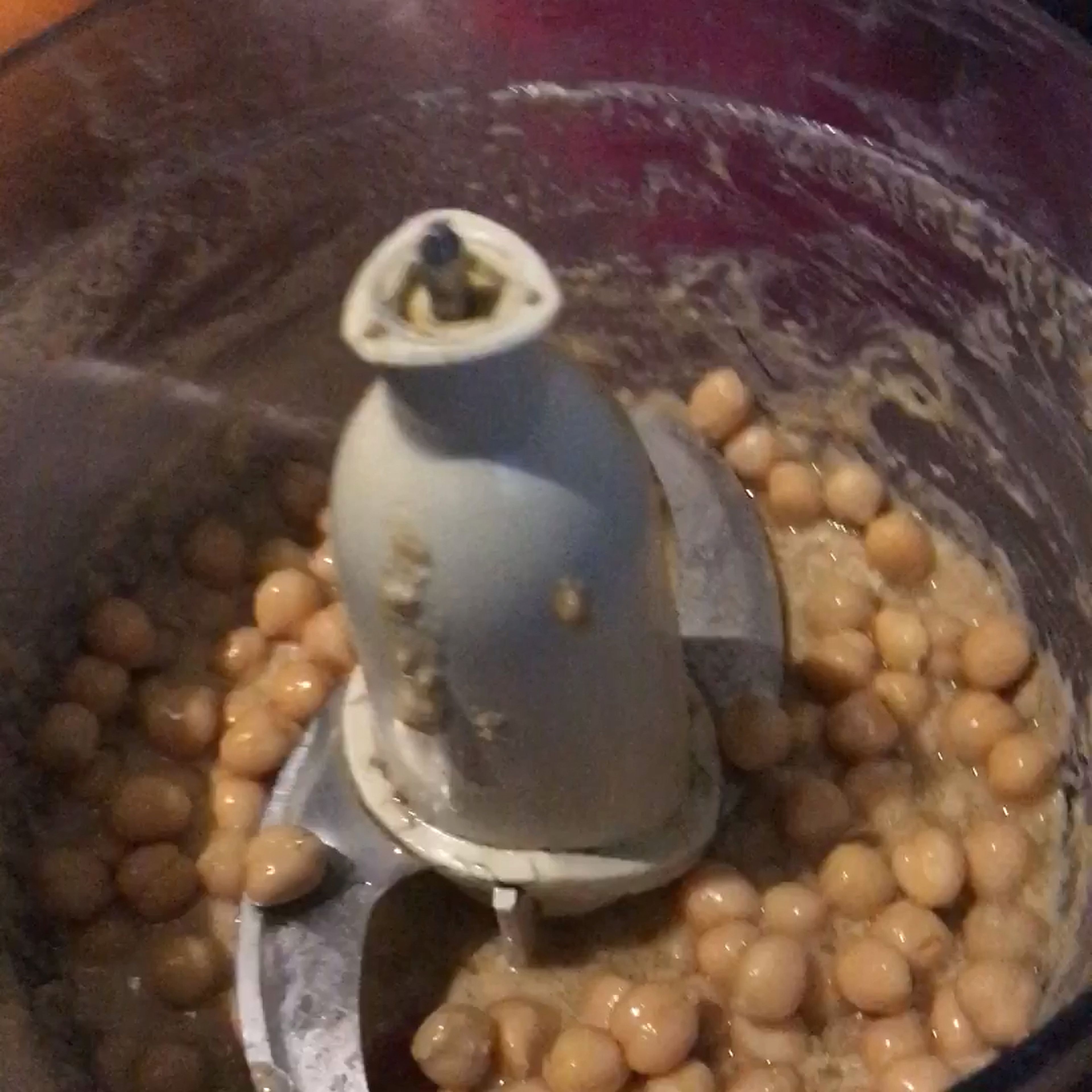 Next you add in half of the chickpeas. Stop the processor in between to scrape the sides again.