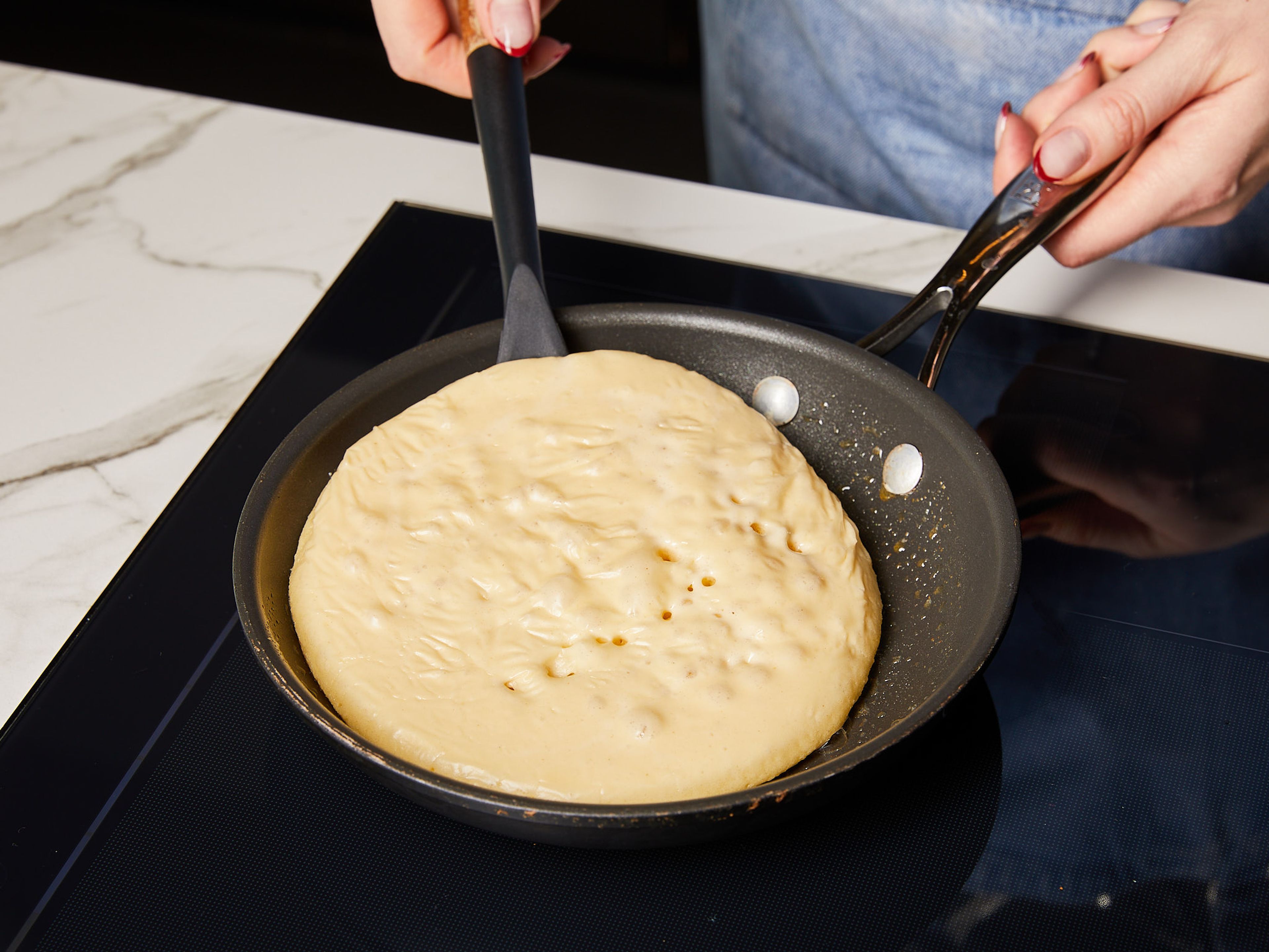 Melt some butter in a pan over medium heat and pour your batter into the pan in batches. When bubbles form on the surface, flip the pancake and let it cook for another 1–2 min. until golden brown. Use more butter to prevent sticking or burning. Transfer to a plate and enjoy with butter and maple syrup.