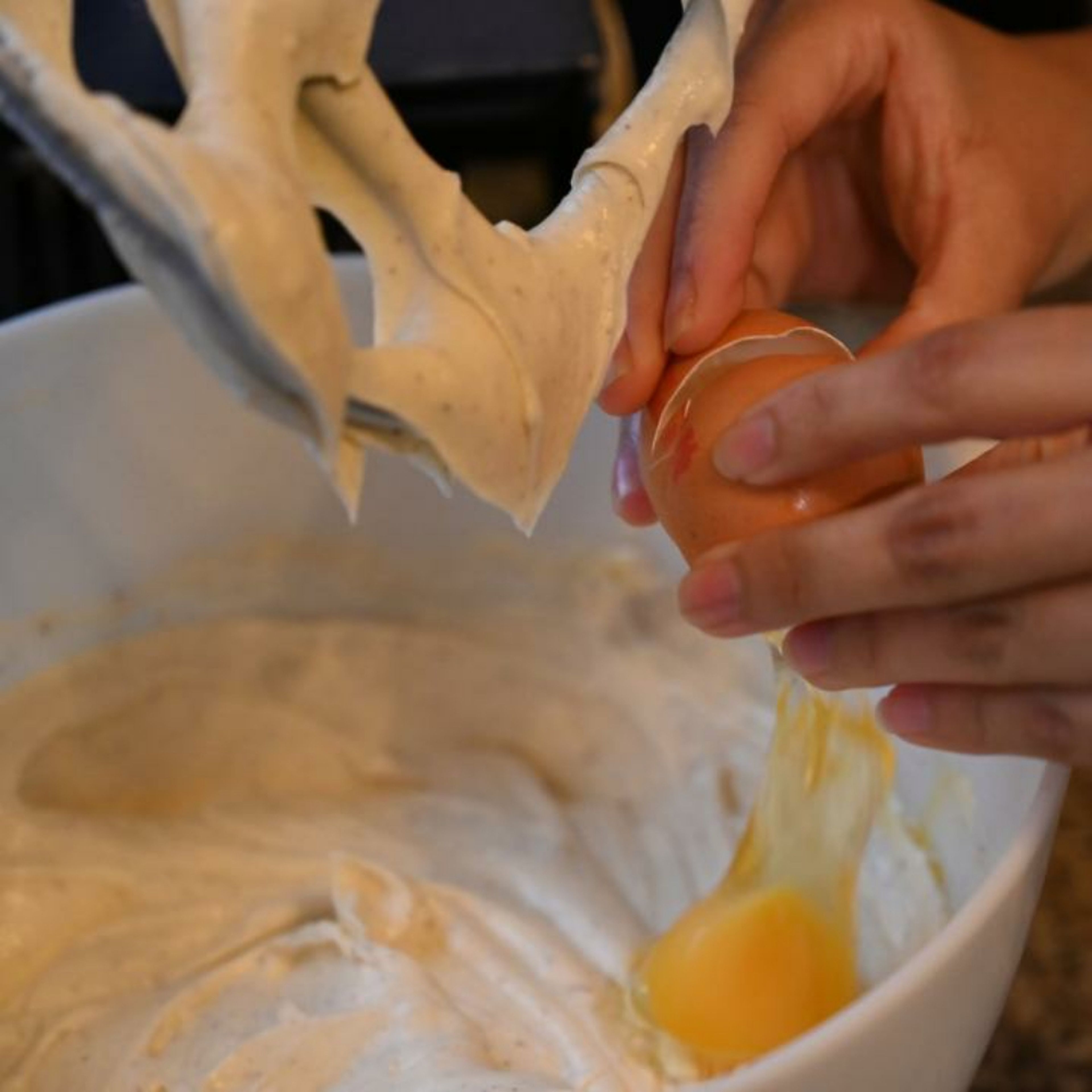 Add the eggs and egg yolks one at a time and continue whisking, until fully combined.