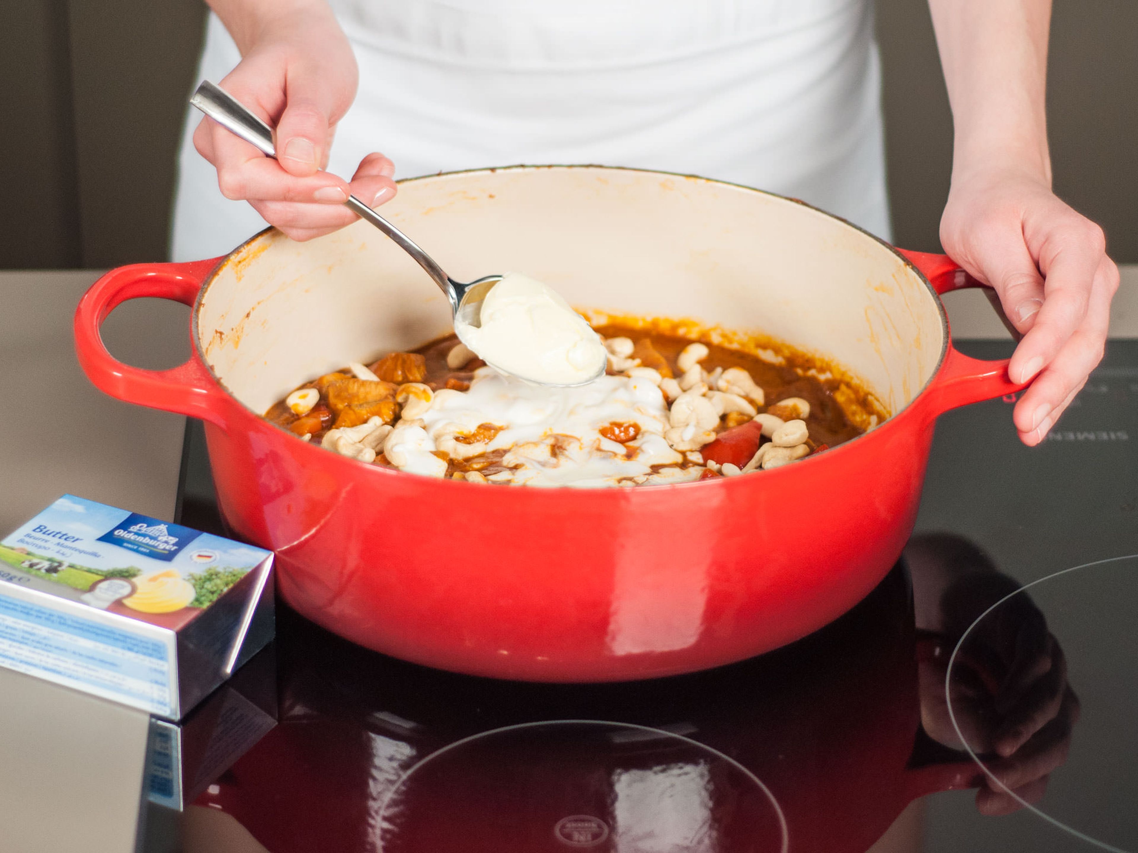 Reduce heat to low and stir in cashews, melted butter, and yogurt. Season to taste.