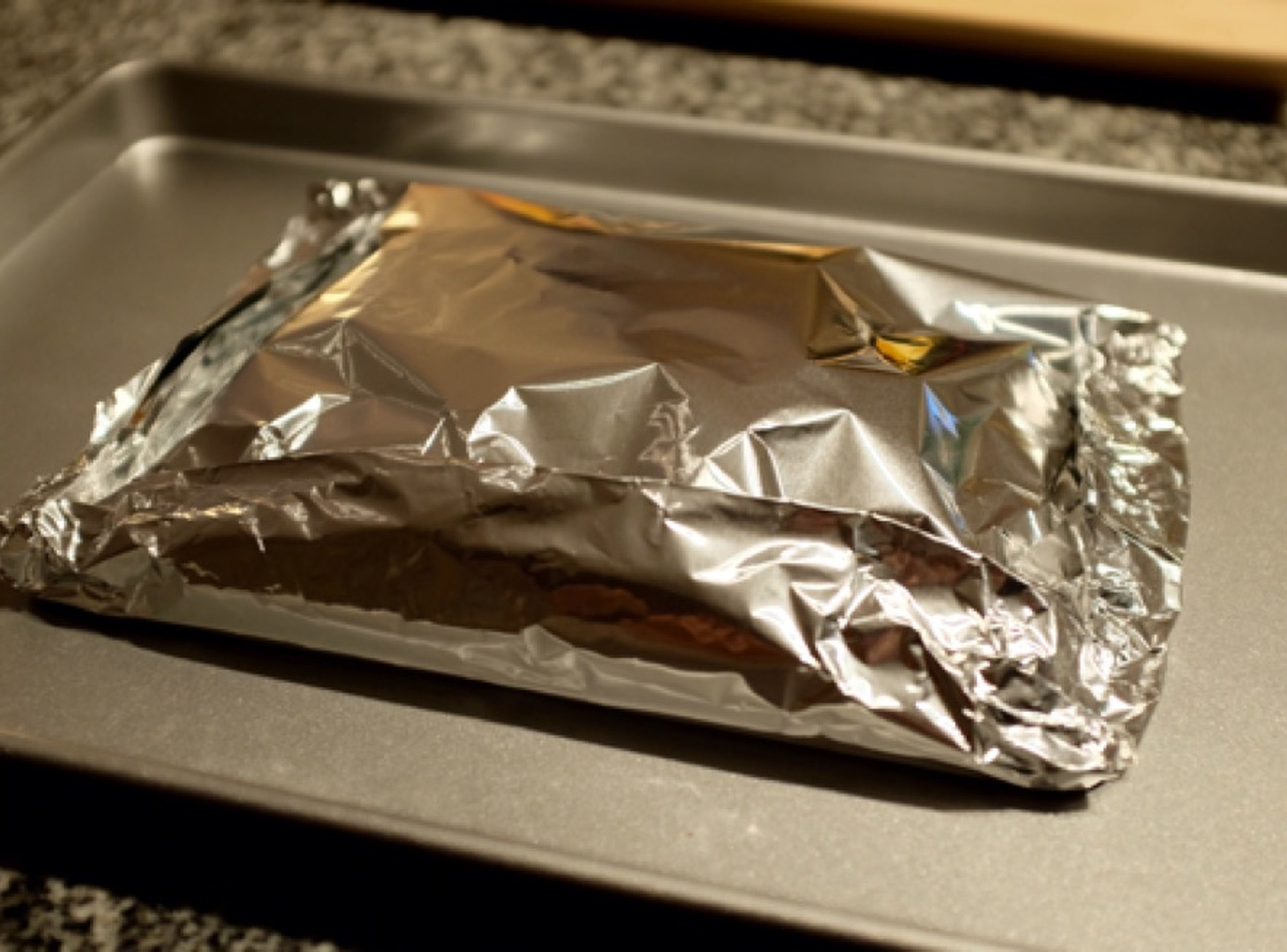 Place another sheet of aluminum foil on top. Fold up the edges of the aluminum foil to create a package and seal the edges well. Transfer baking sheet to oven and bake for approx. 25 min. at 175°C/350°F.