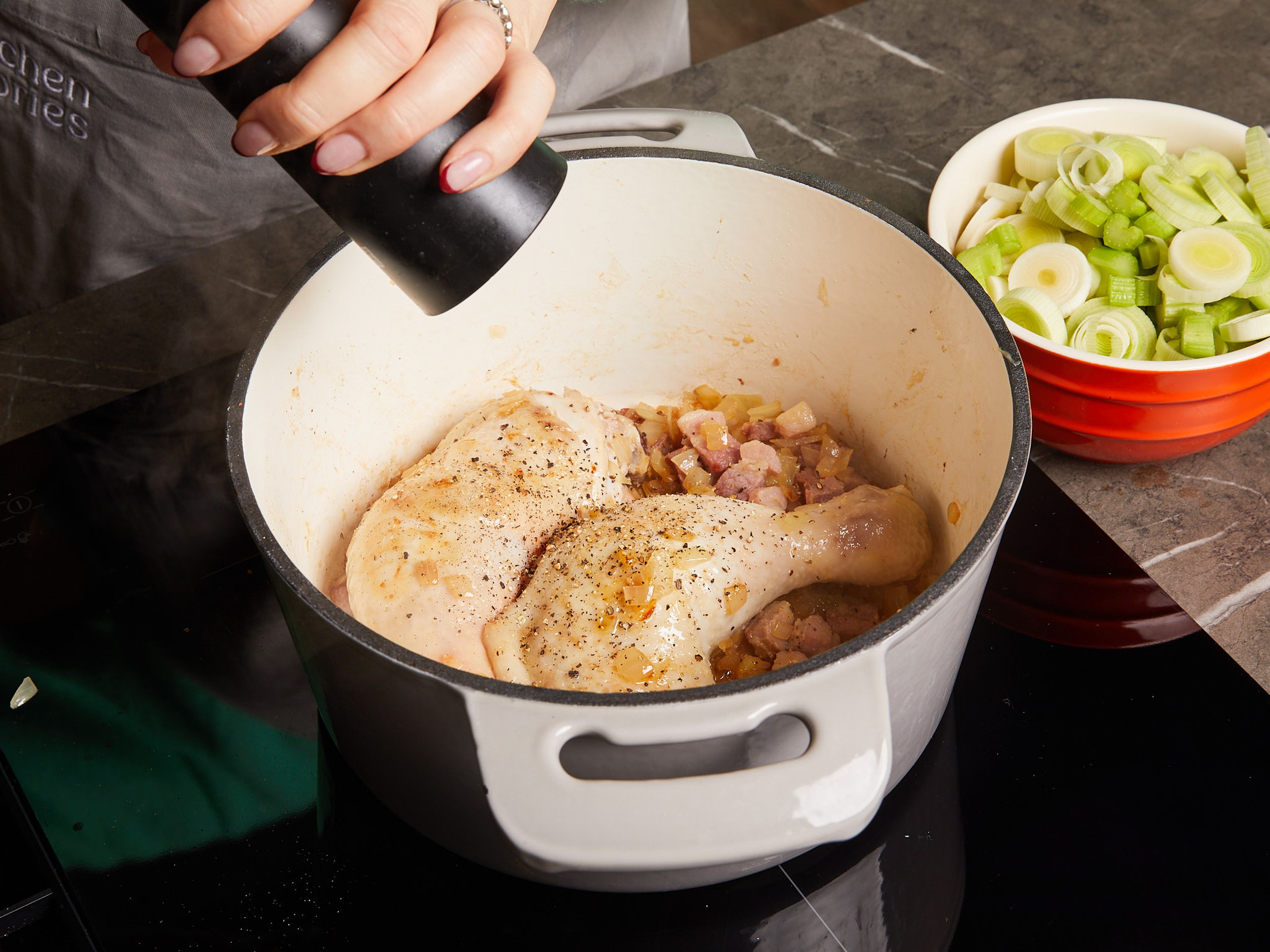 Melt butter in a large pot over medium-high heat. Add onion and bacon and fry for approx. 2–3 min. Add chicken drumsticks and fry for approx. 3–5 min. Season with salt and pepper.