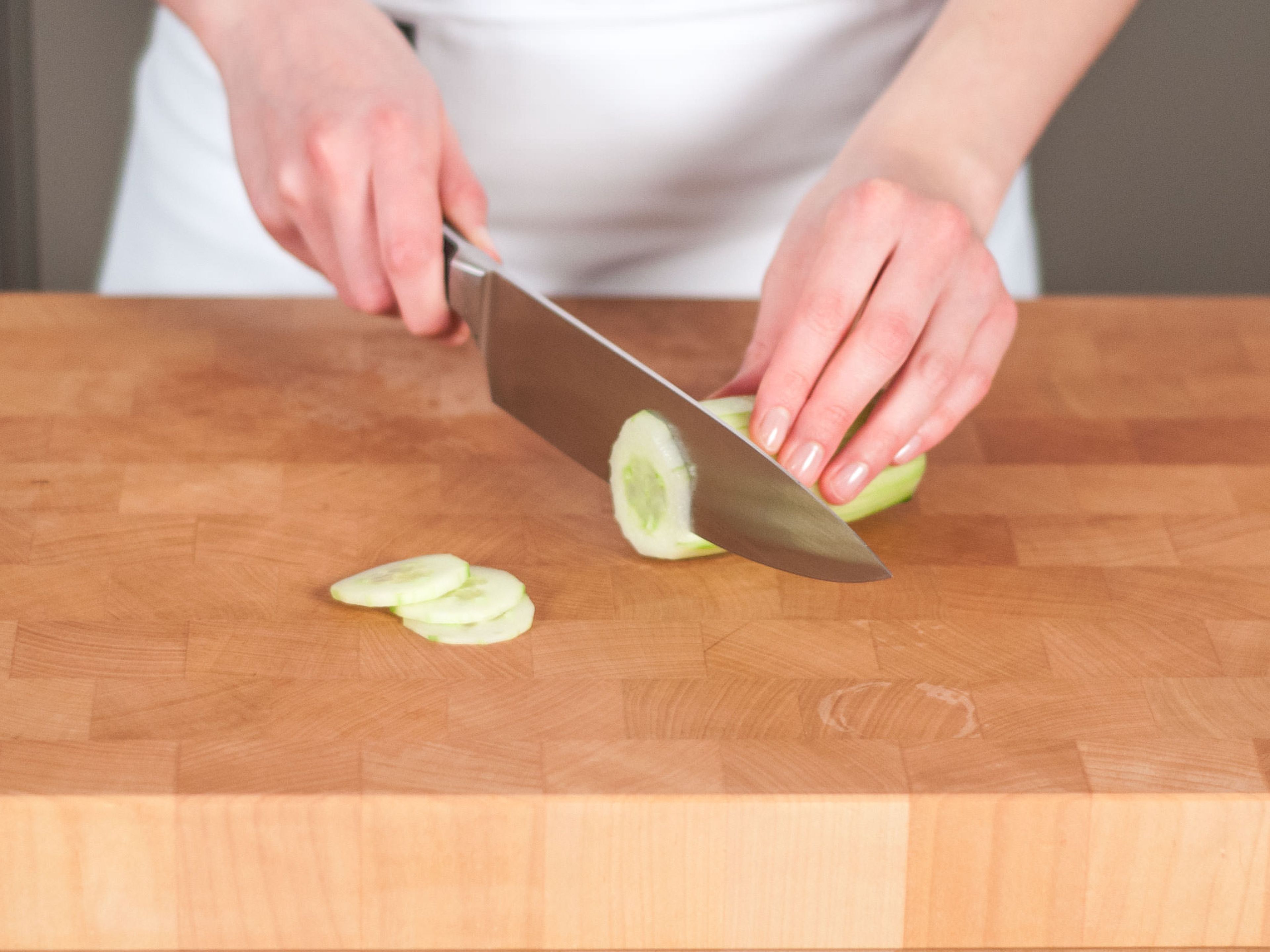 Peel cucumber, and cut crosswise into thin ring-shaped slices.