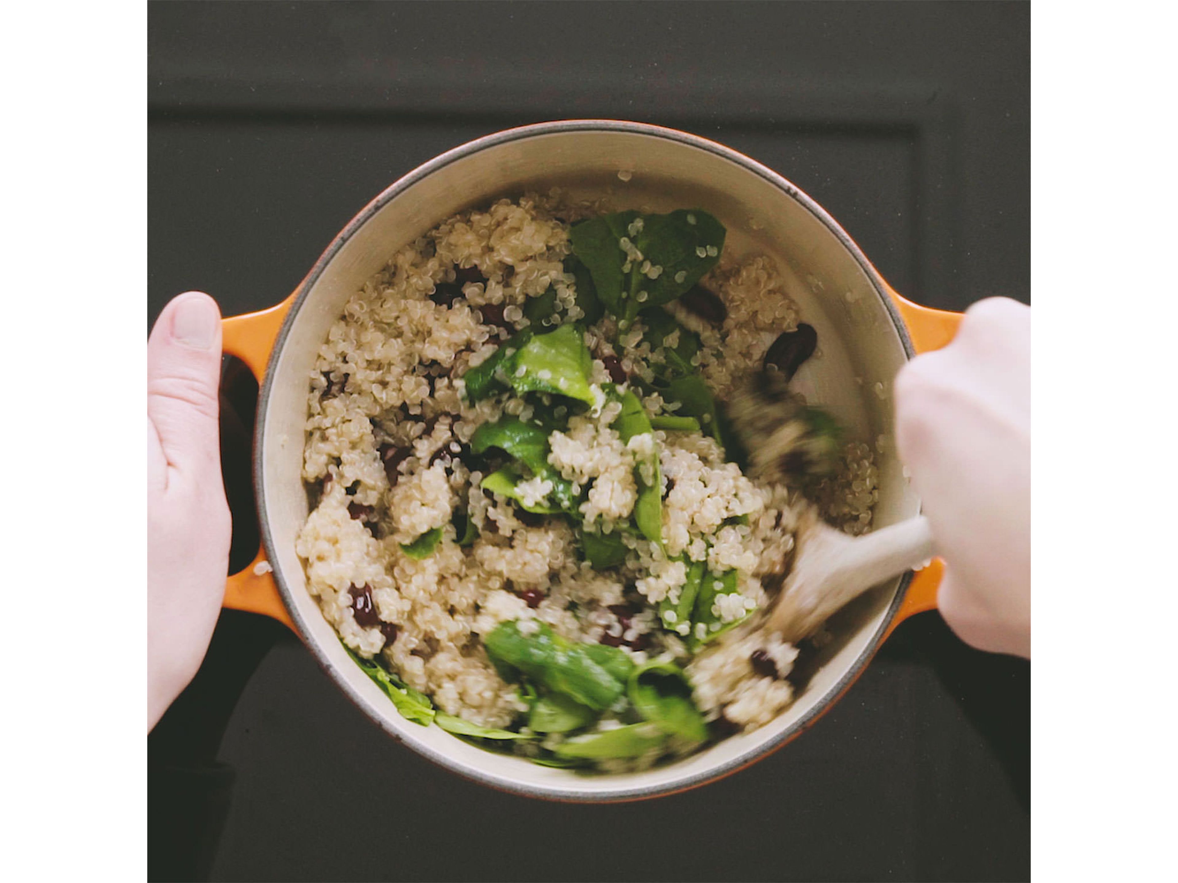 Add cooked quinoa and torn spinach leaves to bean mixture with a pinch of salt. Stir to combine, then partially cover and let cook over low heat for approx. 2 min.