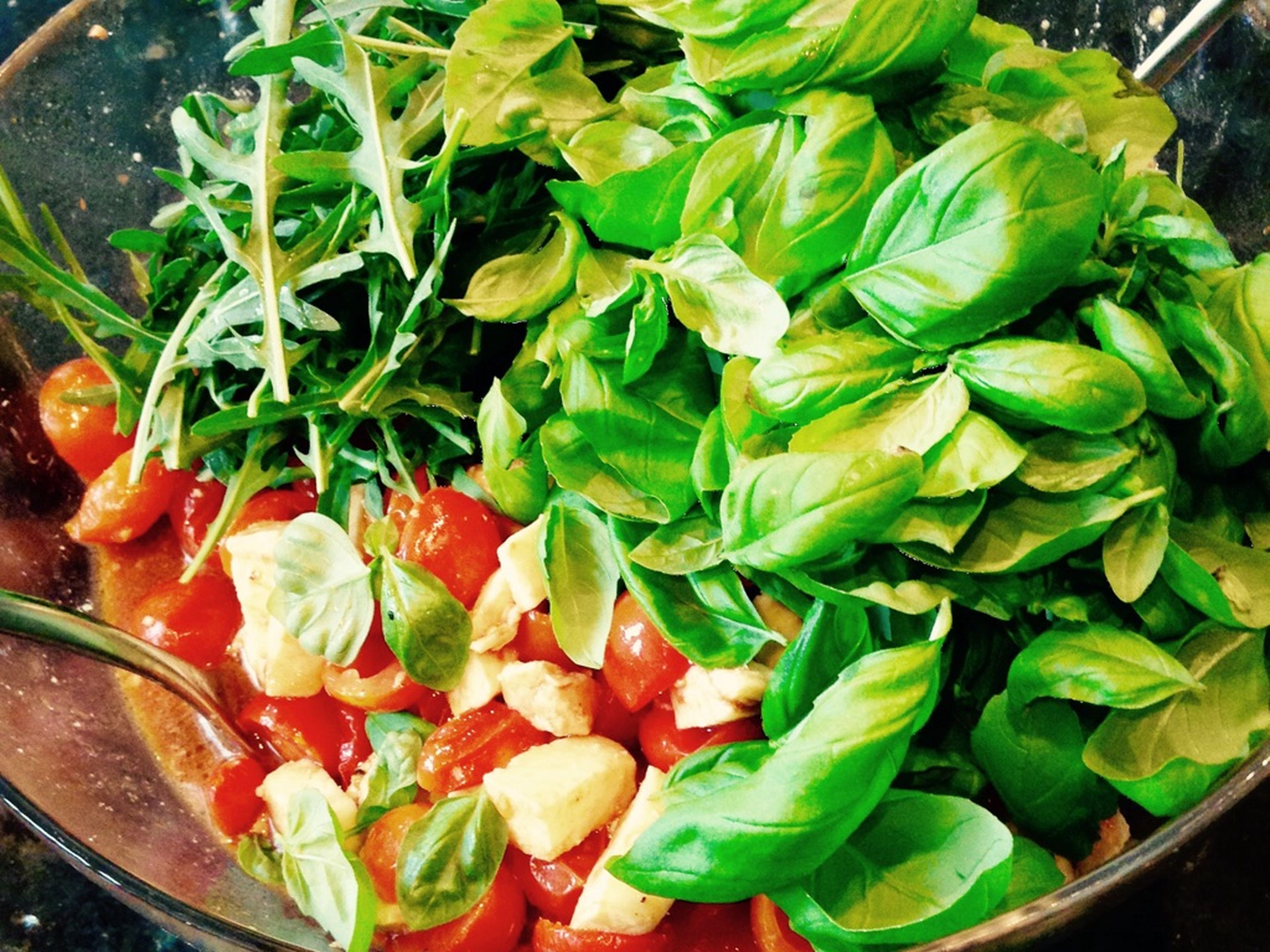 Add arugula and basil leaves to the bowl and stir to combine. Serve with a piece of fresh ciabatta bread or focaccia and enjoy!