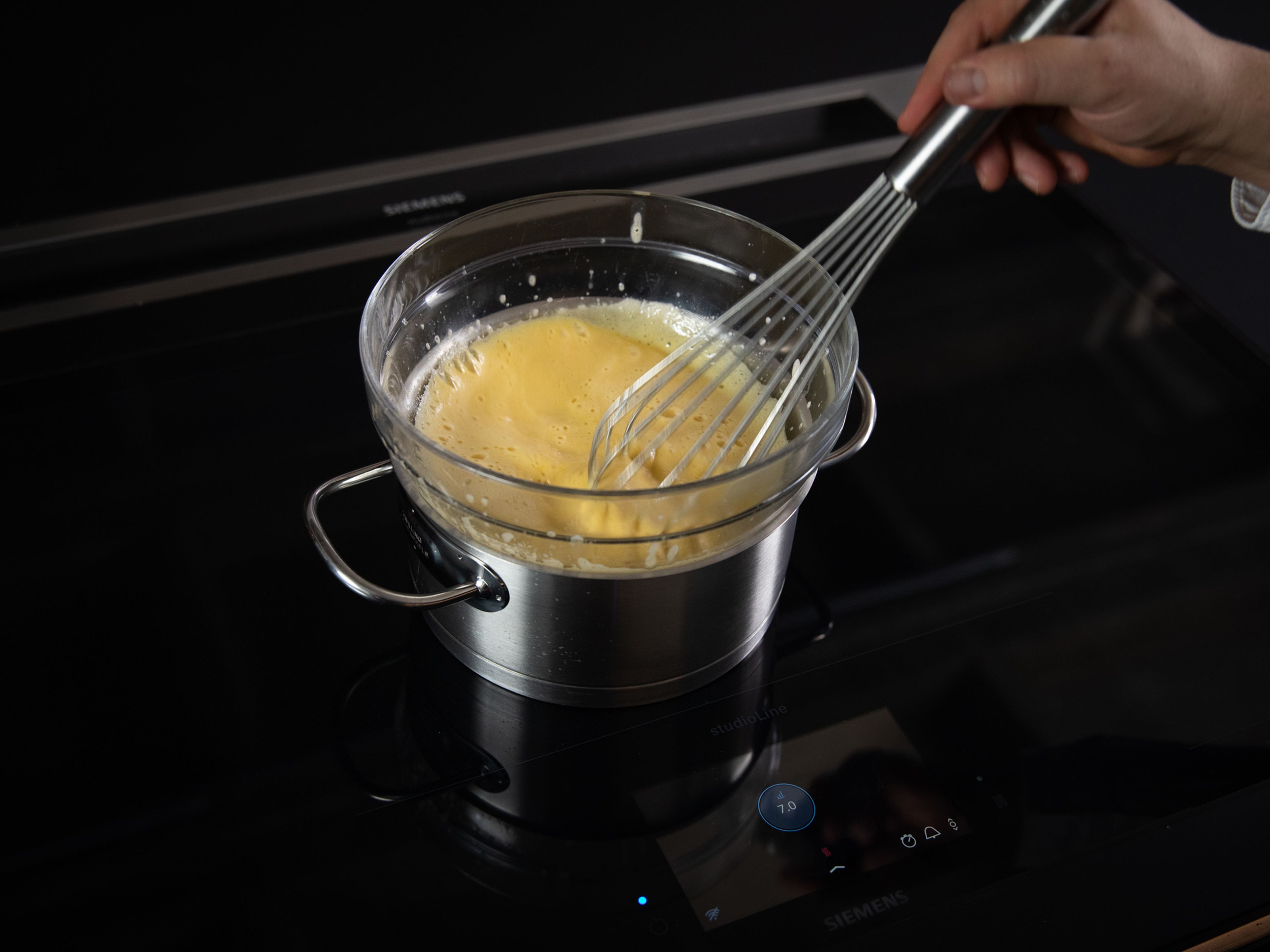 Add egg yolks to a bowl set over a pot of simmering water. Whisk in remaining sugar and Marsala wine. Heat over simmering water, whisking constantly until the mixture is creamy and light.