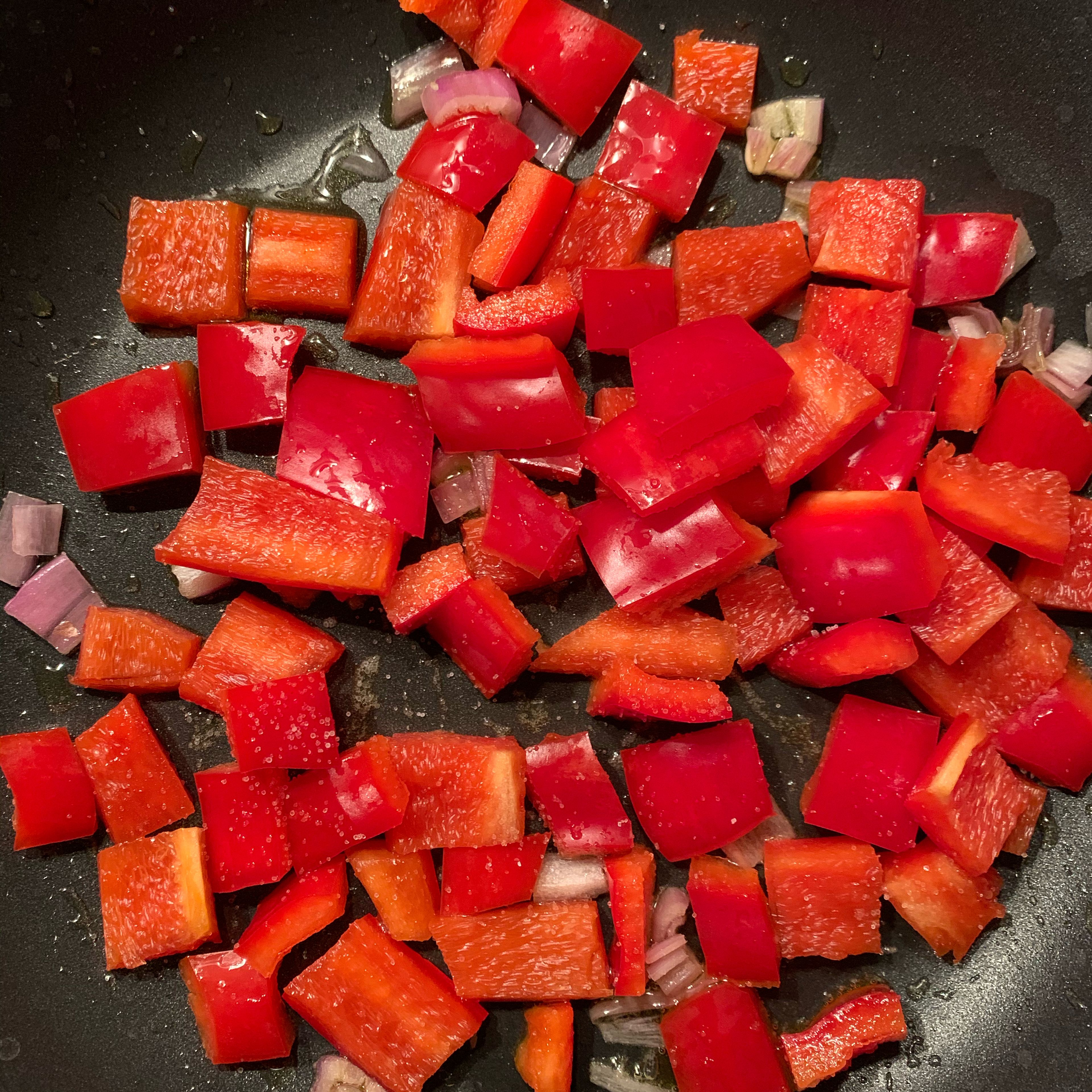 Add olive oil and onion to a frying pan. When golden, add the diced pepper and salt. Let cook for around 10 minutes.