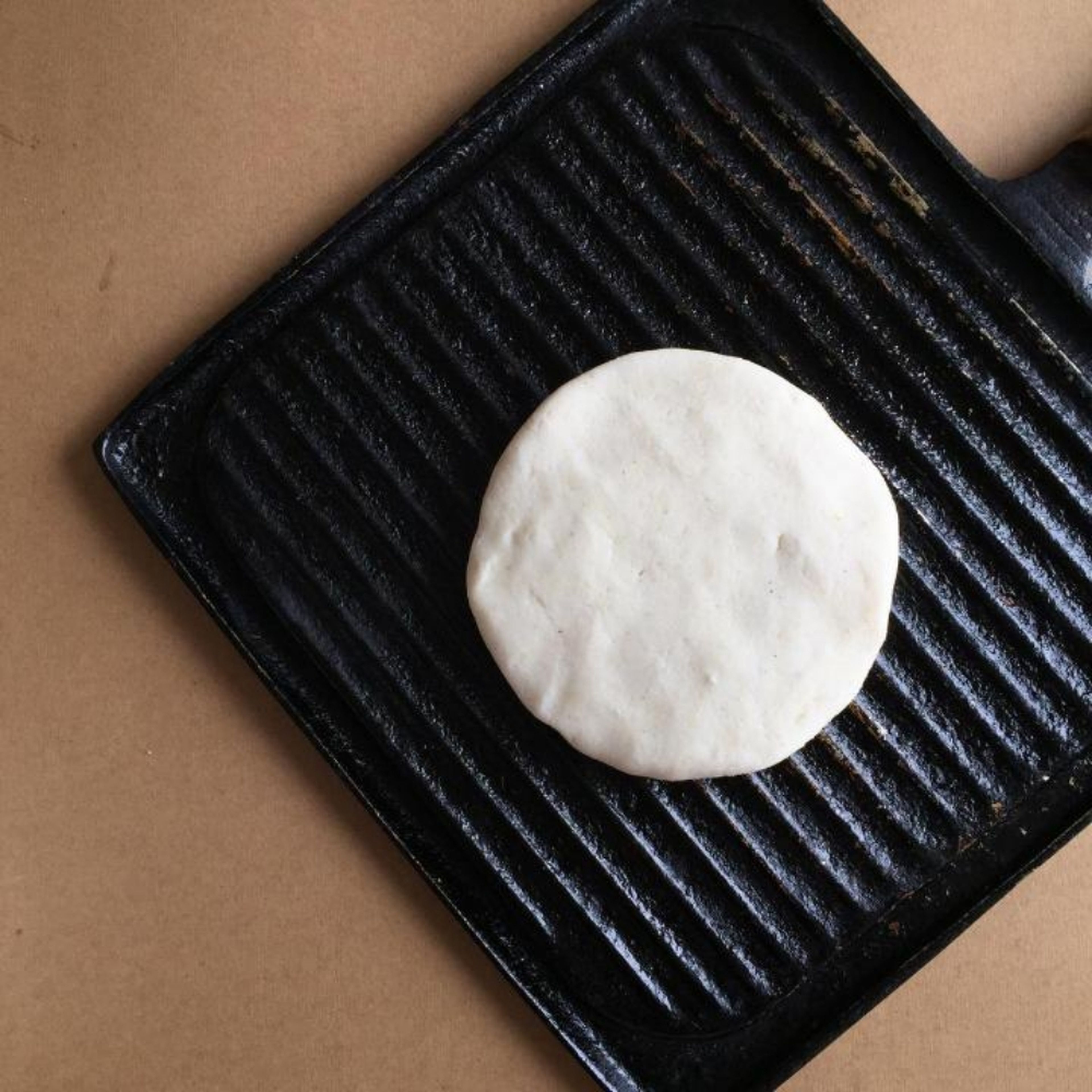 Lightly oil a large iron or grill pan over medium heat. Let the skillet get hot before adding the arepa dough. In batches, add the formed arepas disks to the skillet. Cook each arepa about 4-6 minutes on each side, or until they start to get light brown spots.
