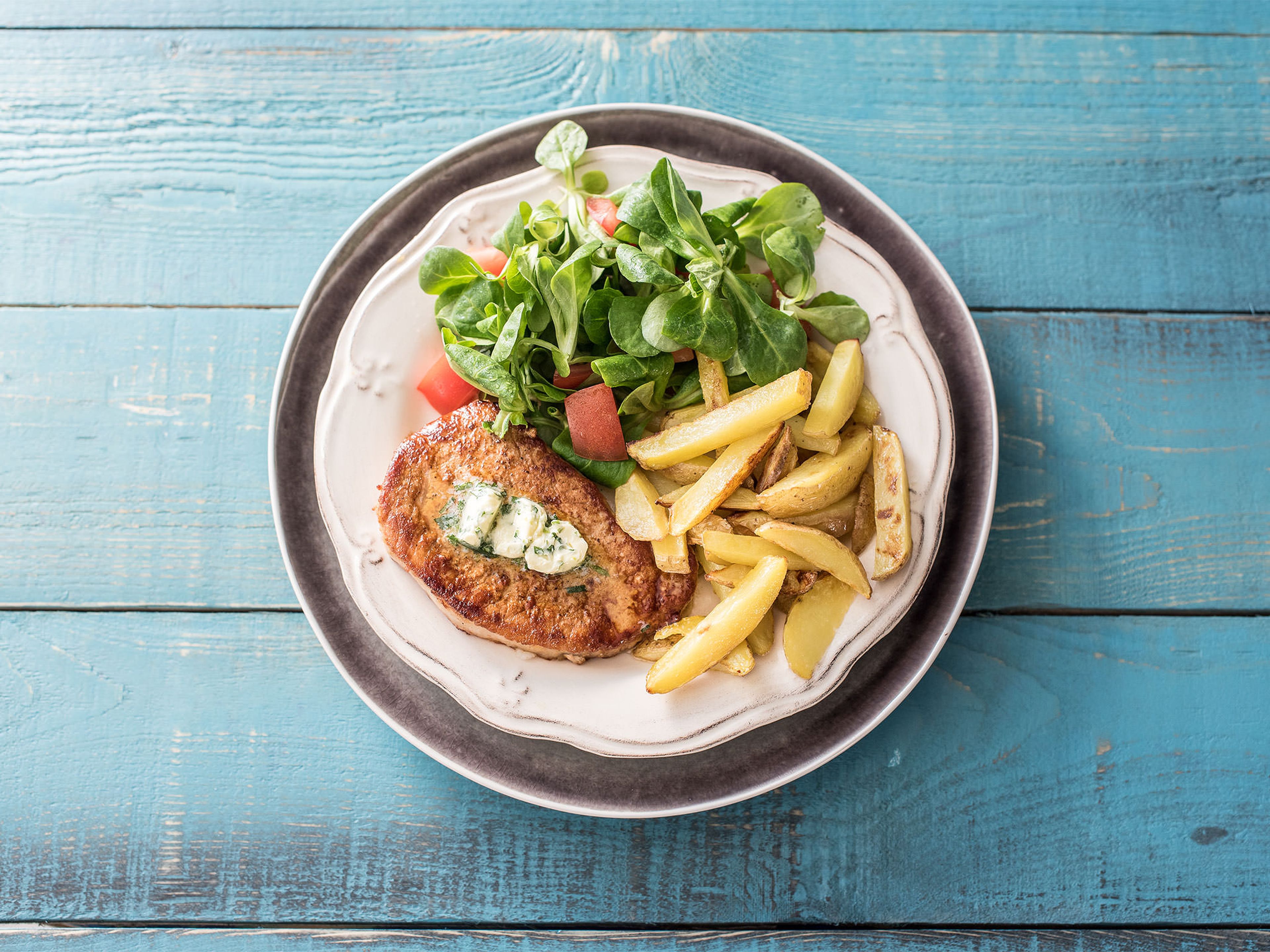 Schweinesteak mit hausgemachten Pommes Frites