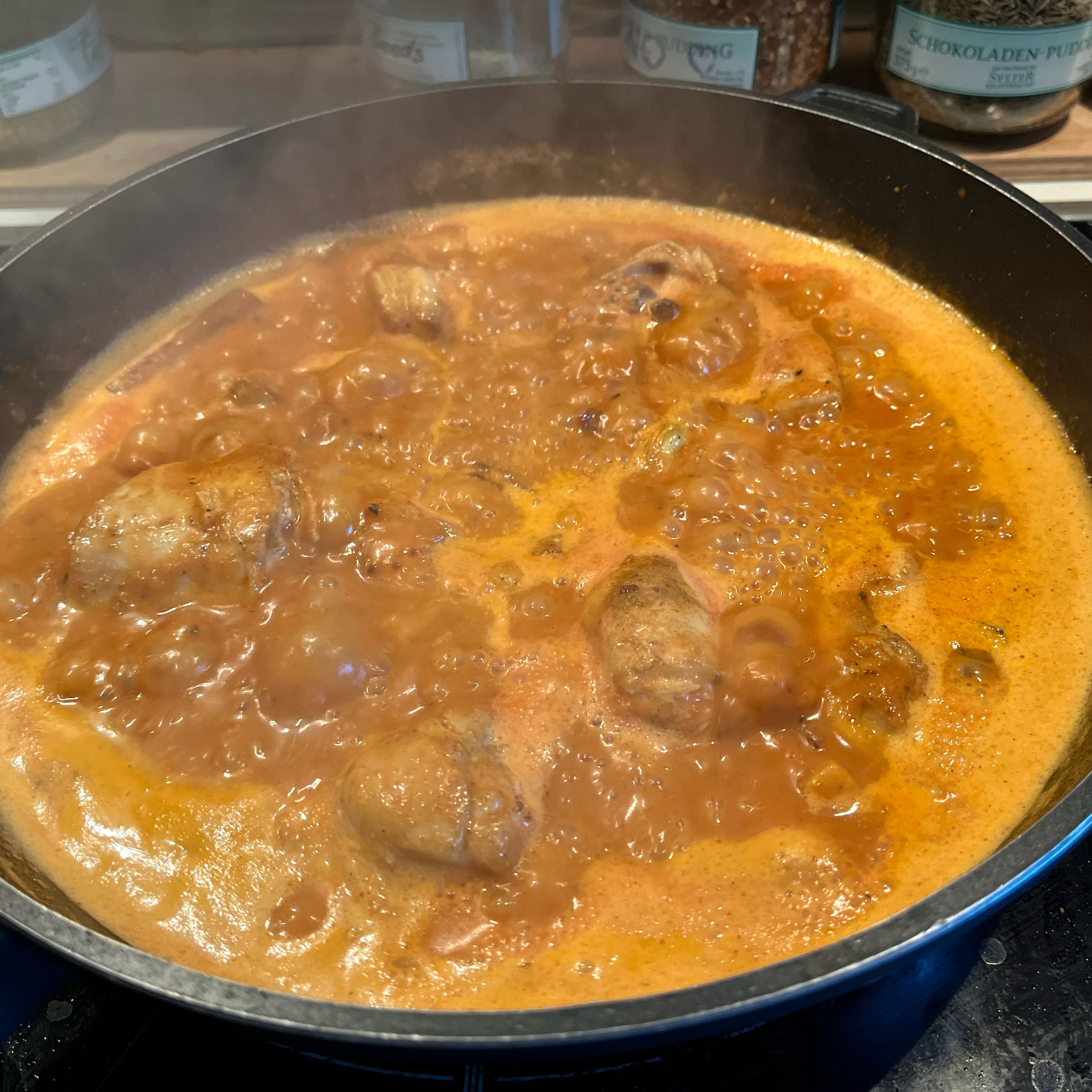 Add tomato purée and bring to a boil, then add coconut milk, stir and bring to a boil again and simmer on low to medium heat until chicken is done (about 30min).