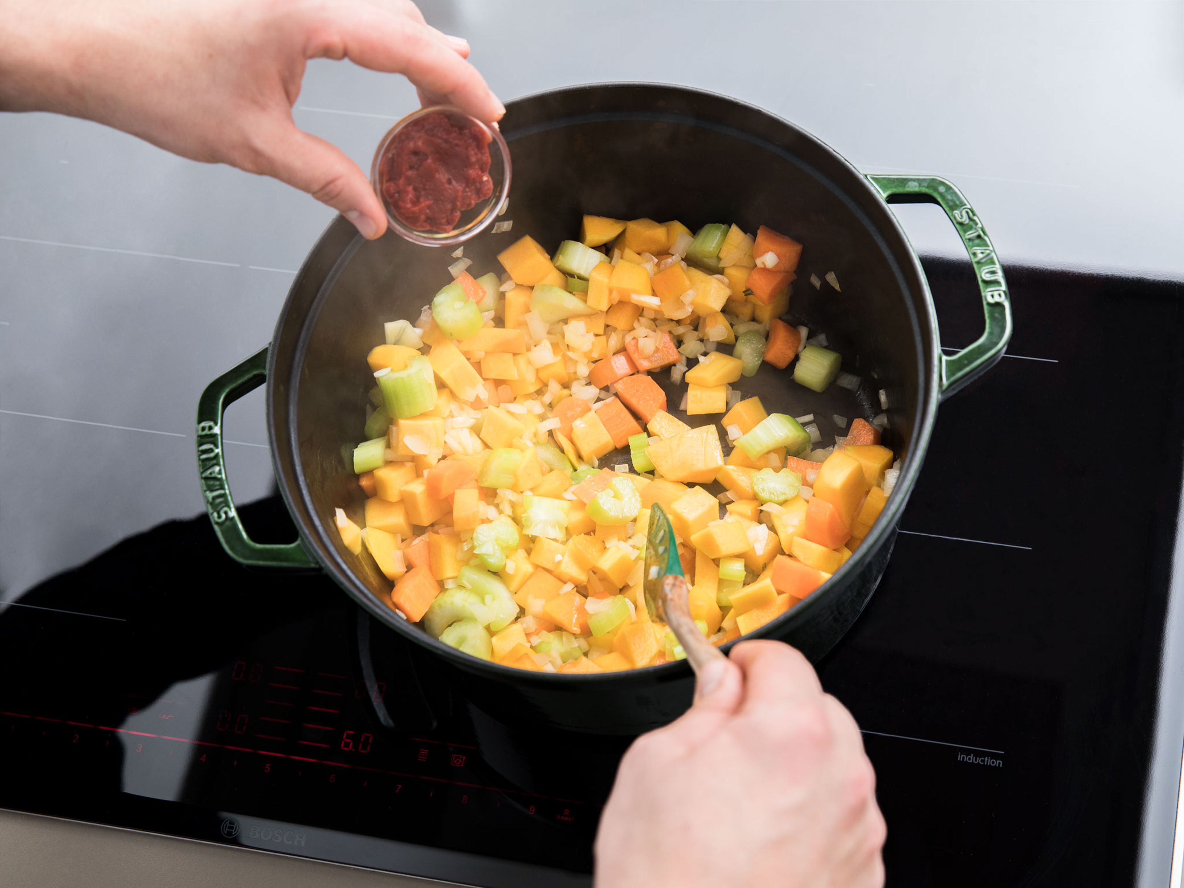 Heat olive oil in a large pot over medium heat. Add onions, carrots, butternut squash, and celery and fry for approx. 5 min. Add garlic and fry for another approx. 1 – 2 min. Add tomato paste and chopped herbs and keep frying for approx. 3 min.