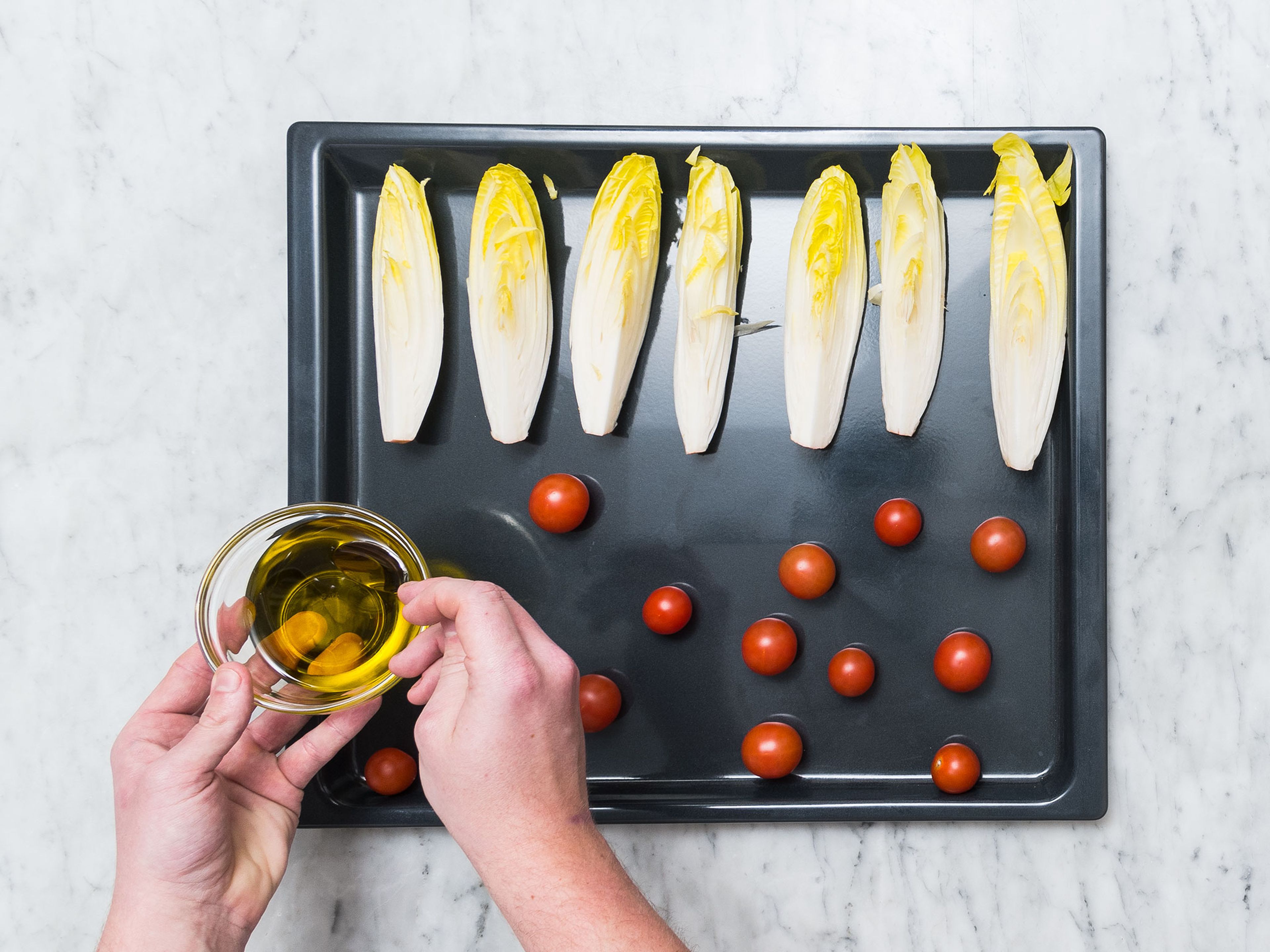 Pre-heat oven to 180°C/350°F. Wash endive and quarter. Transfer endive and tomatoes onto a baking sheet, drizzle with some olive oil, and season with salt, pepper, and sugar to taste. Roast in oven for approx. 8 – 10 min.