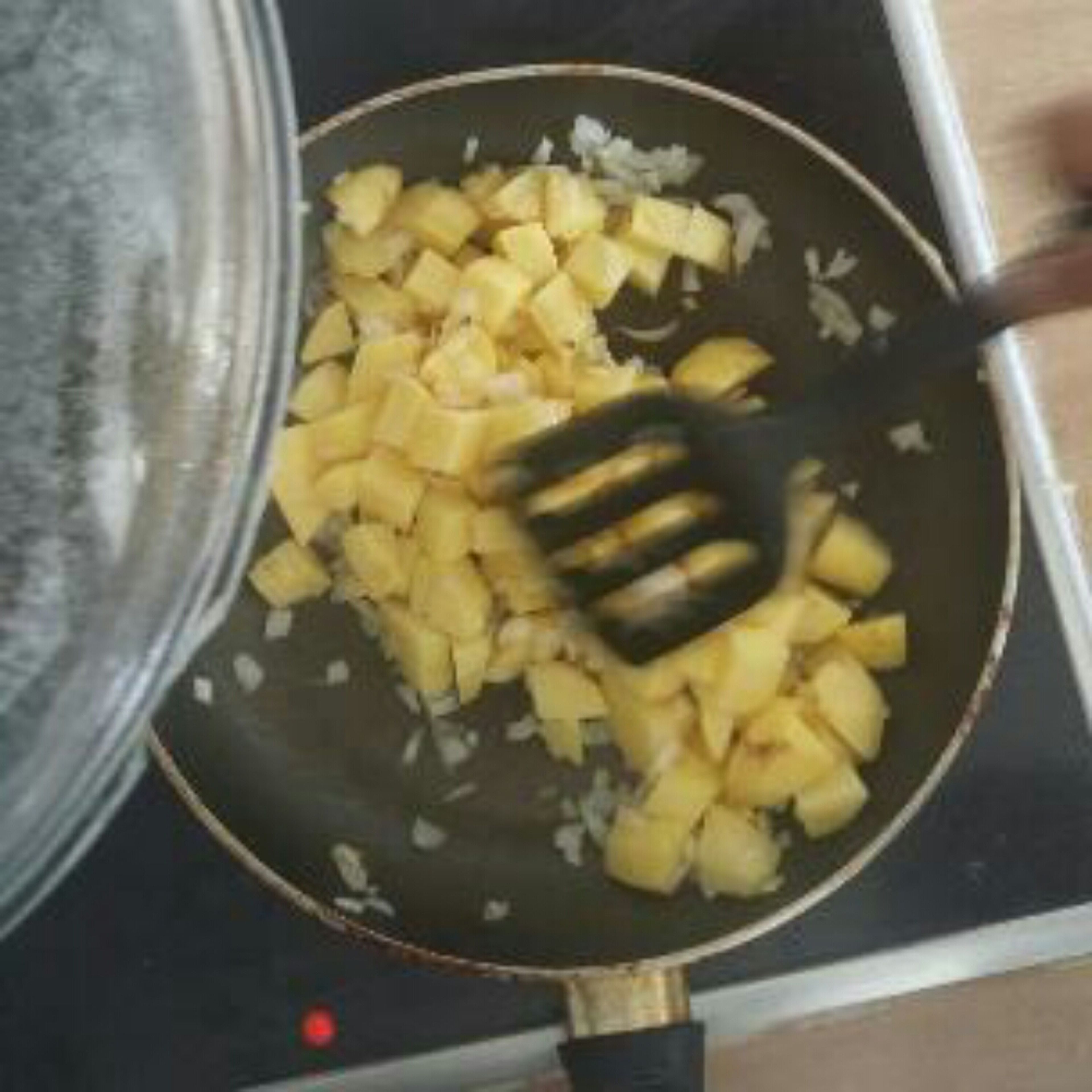 fry the onions, then add potatos and carrots and some water
