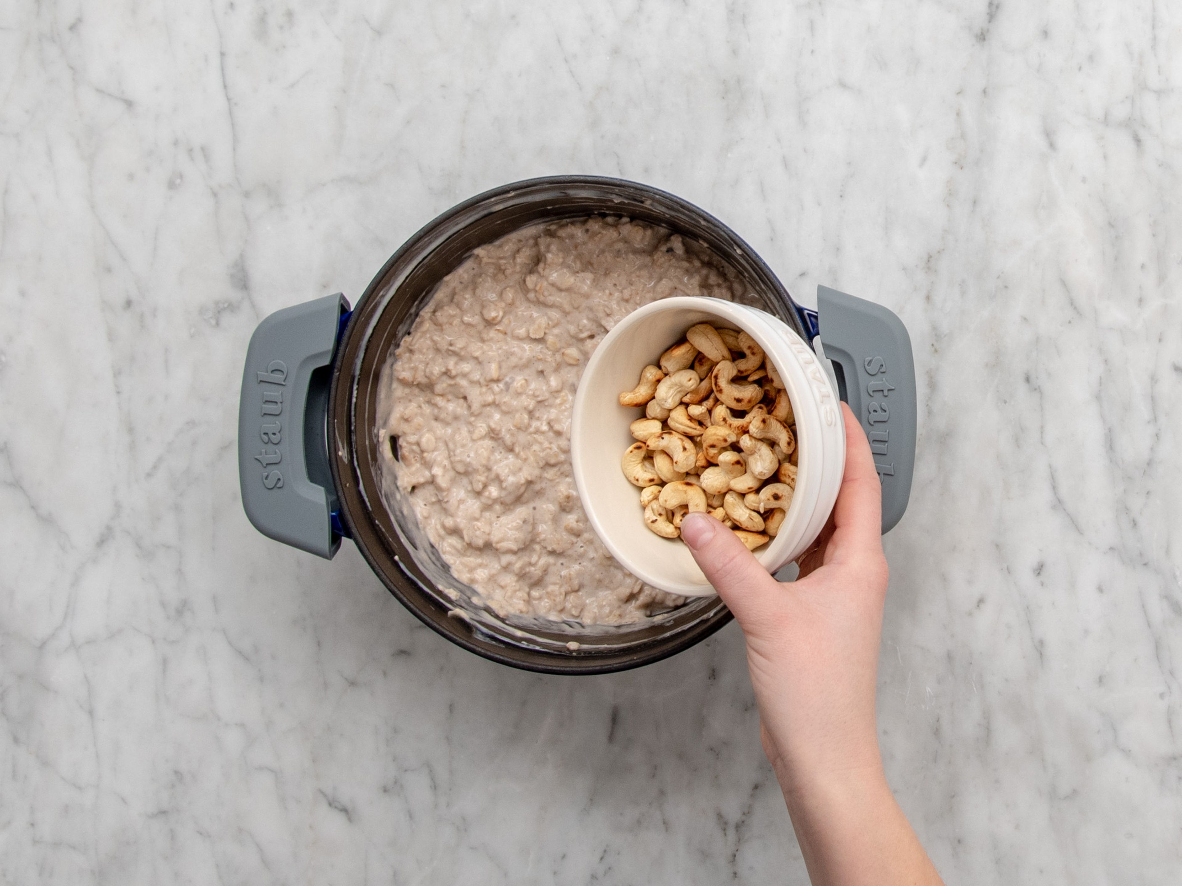 As soon as the porridge is done, remove from heat, add toasted cashews and honey, and stir to combine.