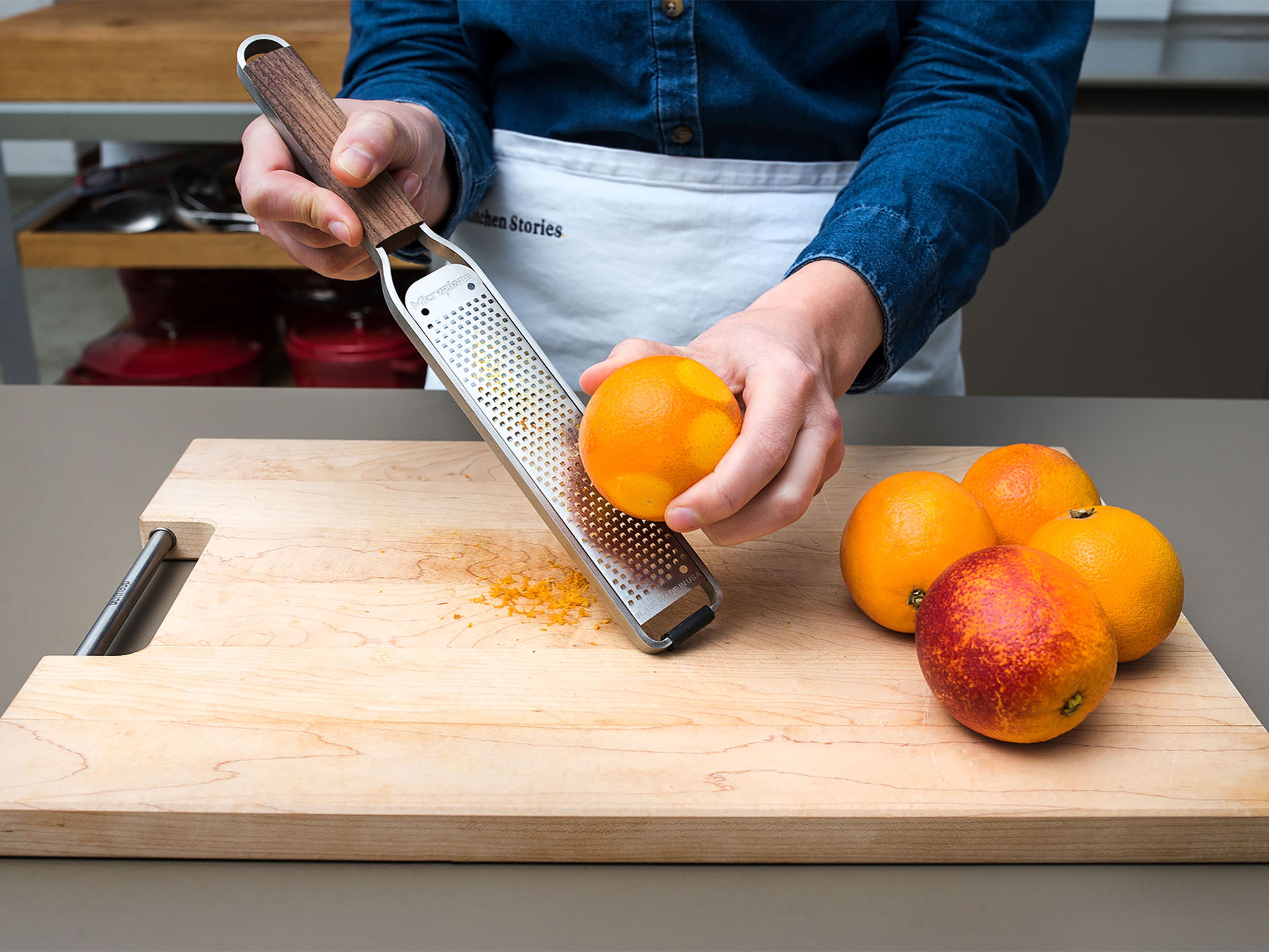 Pre-heat oven to 175°C/350°F. Rinse the blood oranges thoroughly with hot water and, using a fine grater, grate the zest of 1/5 of the oranges. Reserve zest. Cut off the top and bottom of the blood oranges and carefully removing the peel if you’d like. Slice the oranges thinly, removing any of the pithy core.