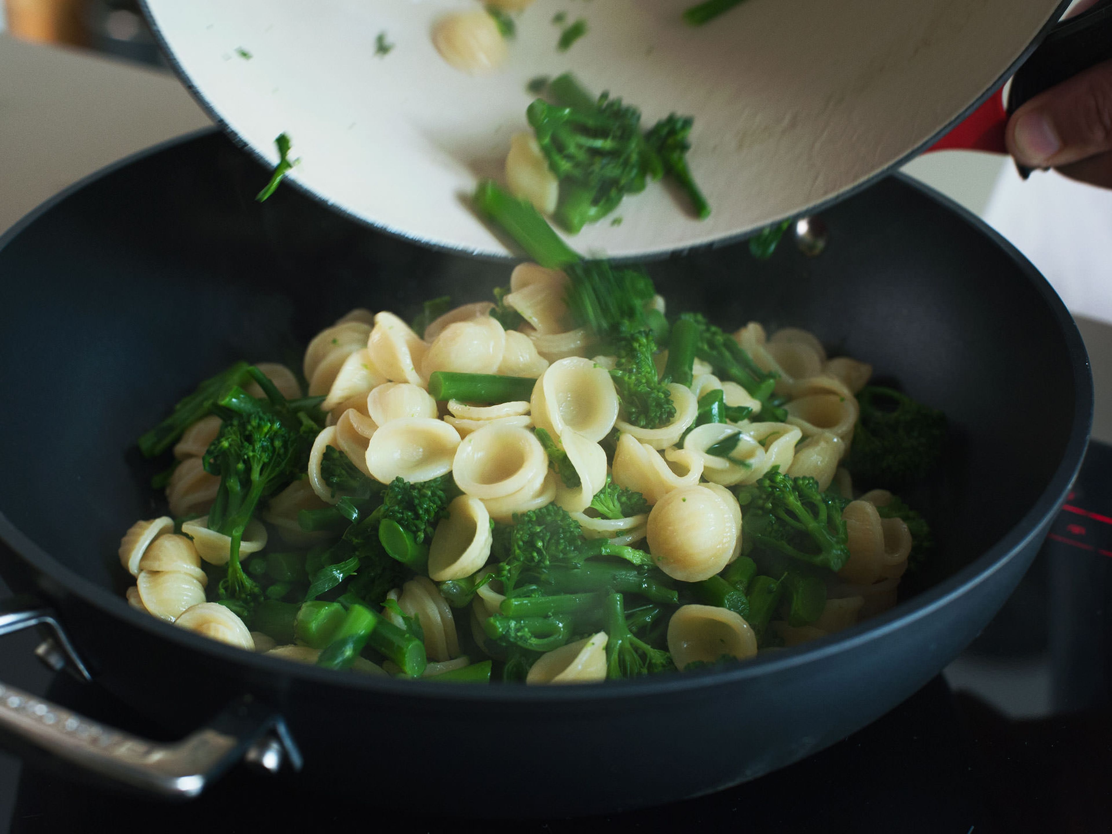 Add orecchiette and rapini to pan and sauté for an additional 2 – 3 min. over high heat until warm.