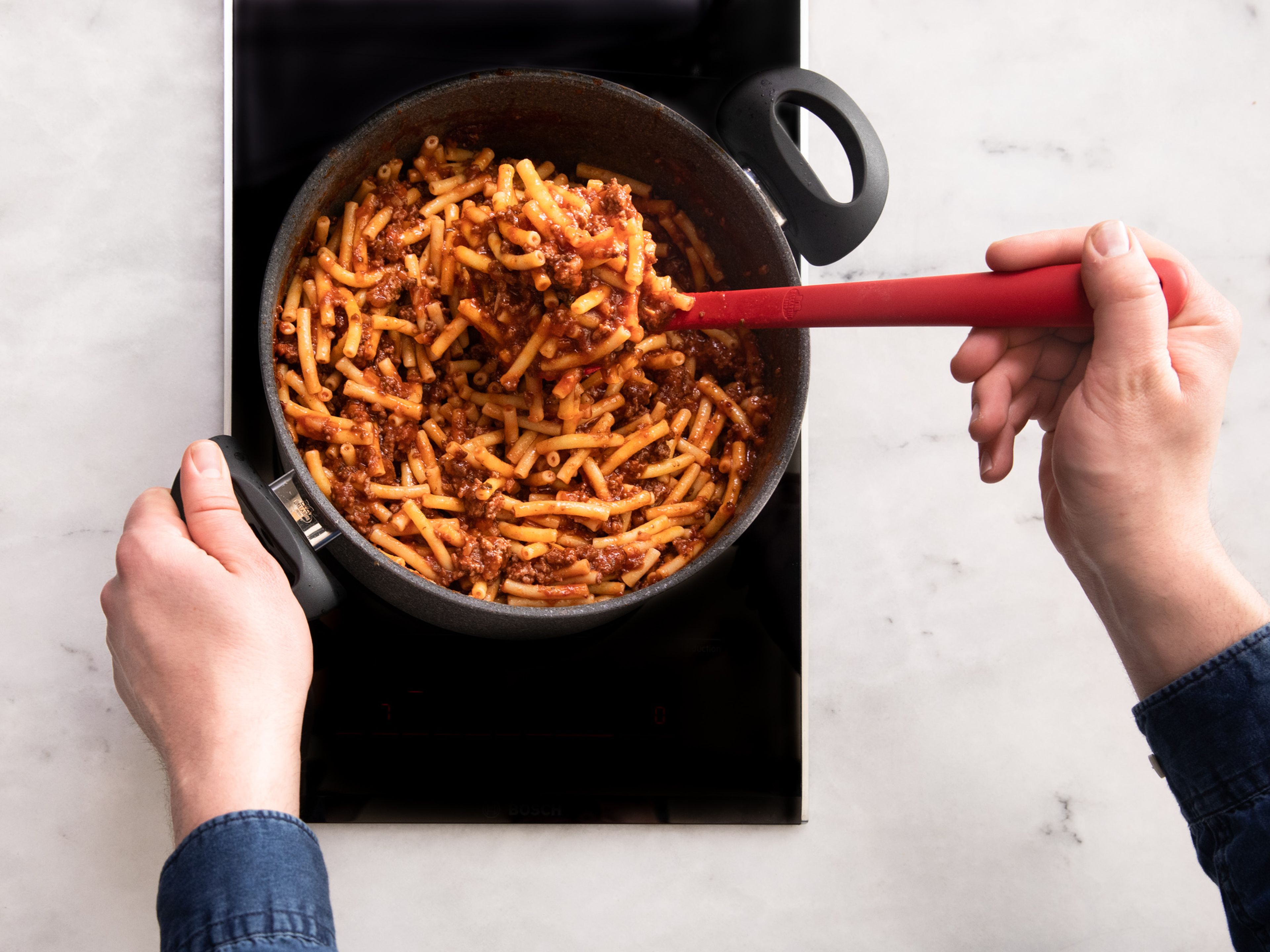 When the bolognese is almost ready, boil the macaroni in plenty of salted
water until al dente or according to the package instructions. Drain and add to the bolognese. Toss to combine then serve with shredded Parmesan cheese. Enjoy!