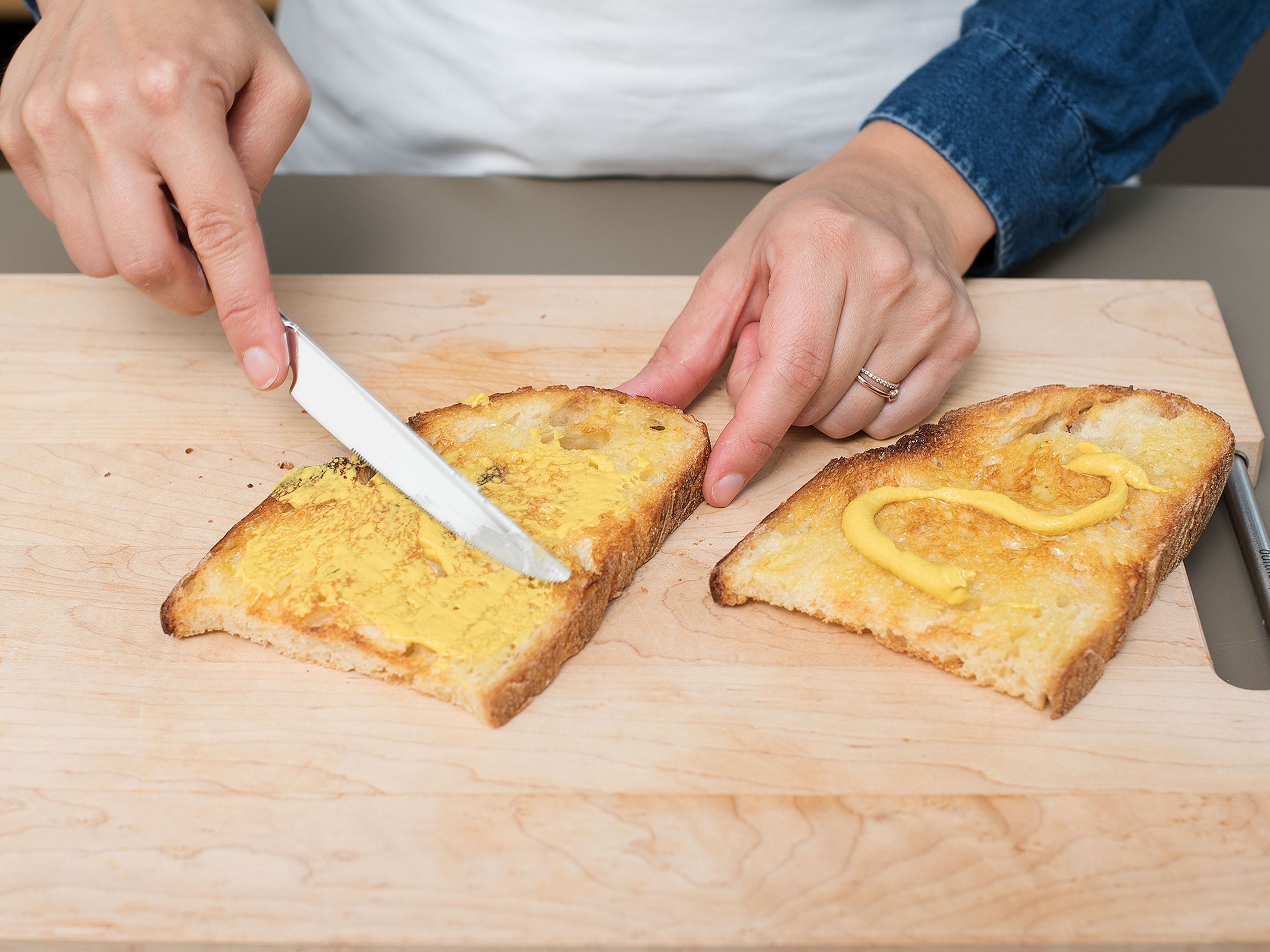 Brotscheiben toasten und mit Butter und Senf bestreichen. Rucola waschen und trocknen.