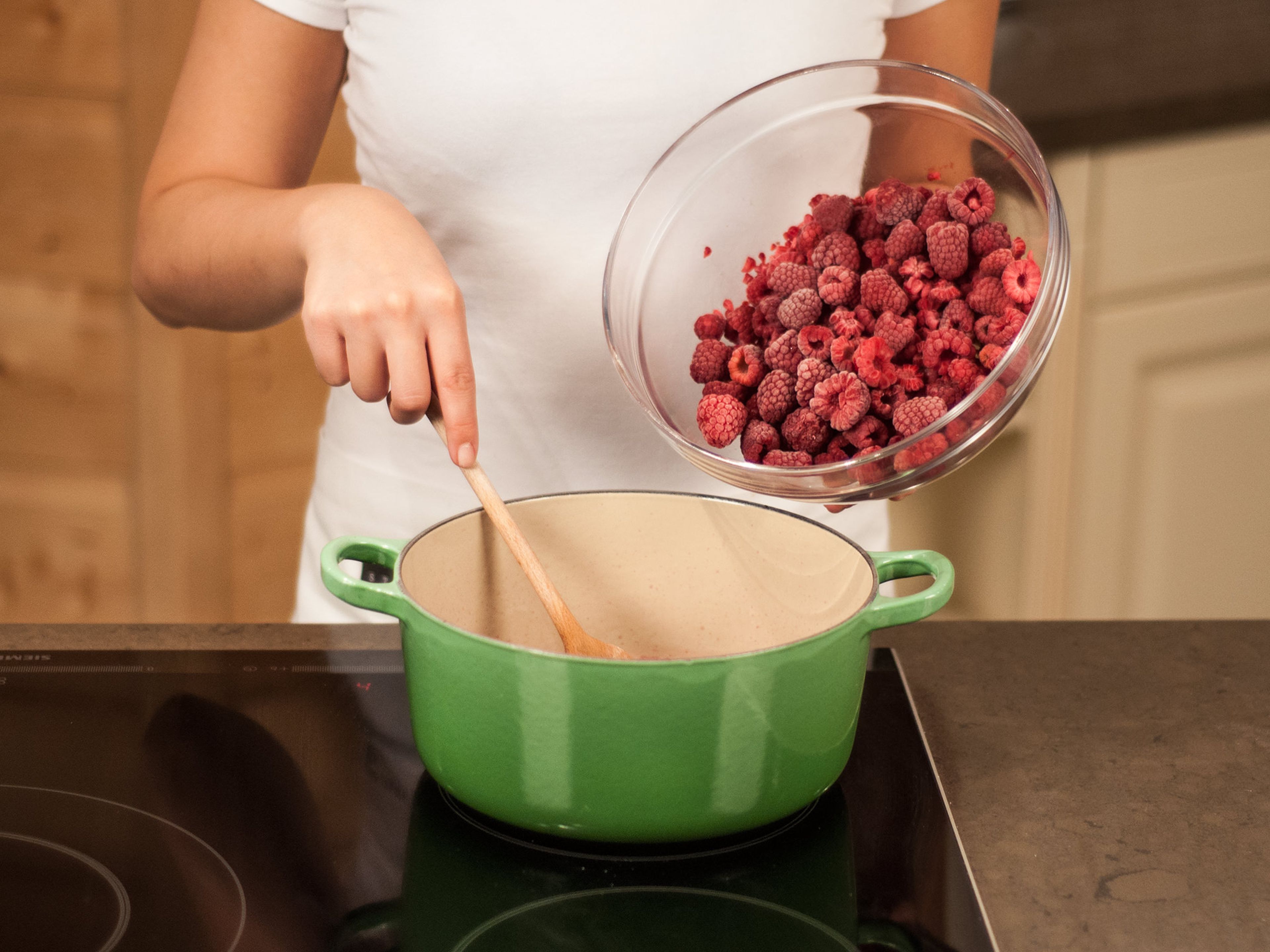 Then, add the raspberries and let them sit in the hot mixture for approx. 10 min. until they are fully warmed through. Do not let the mixture boil anymore since that will destroy the structure of the raspberries.